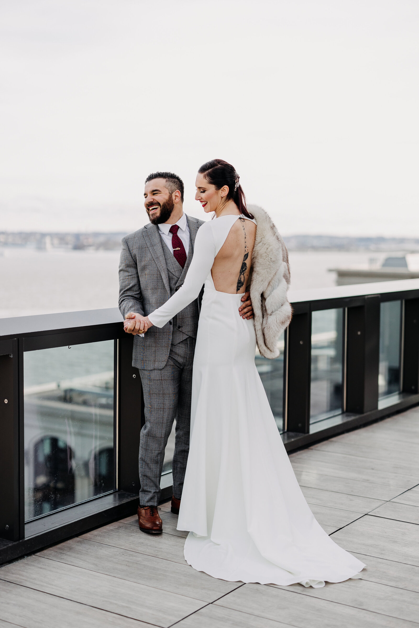 bride and groom at jersey city skyline rooftop