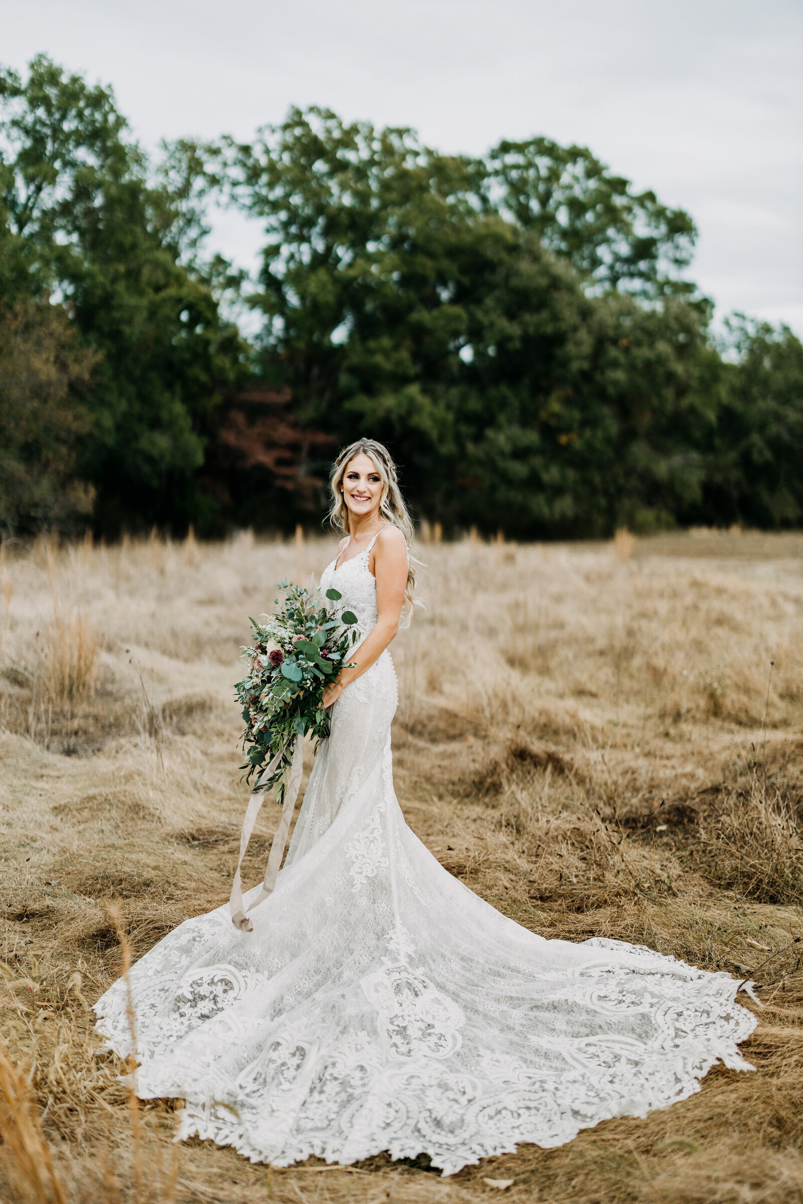 bride in lace dress in fall field