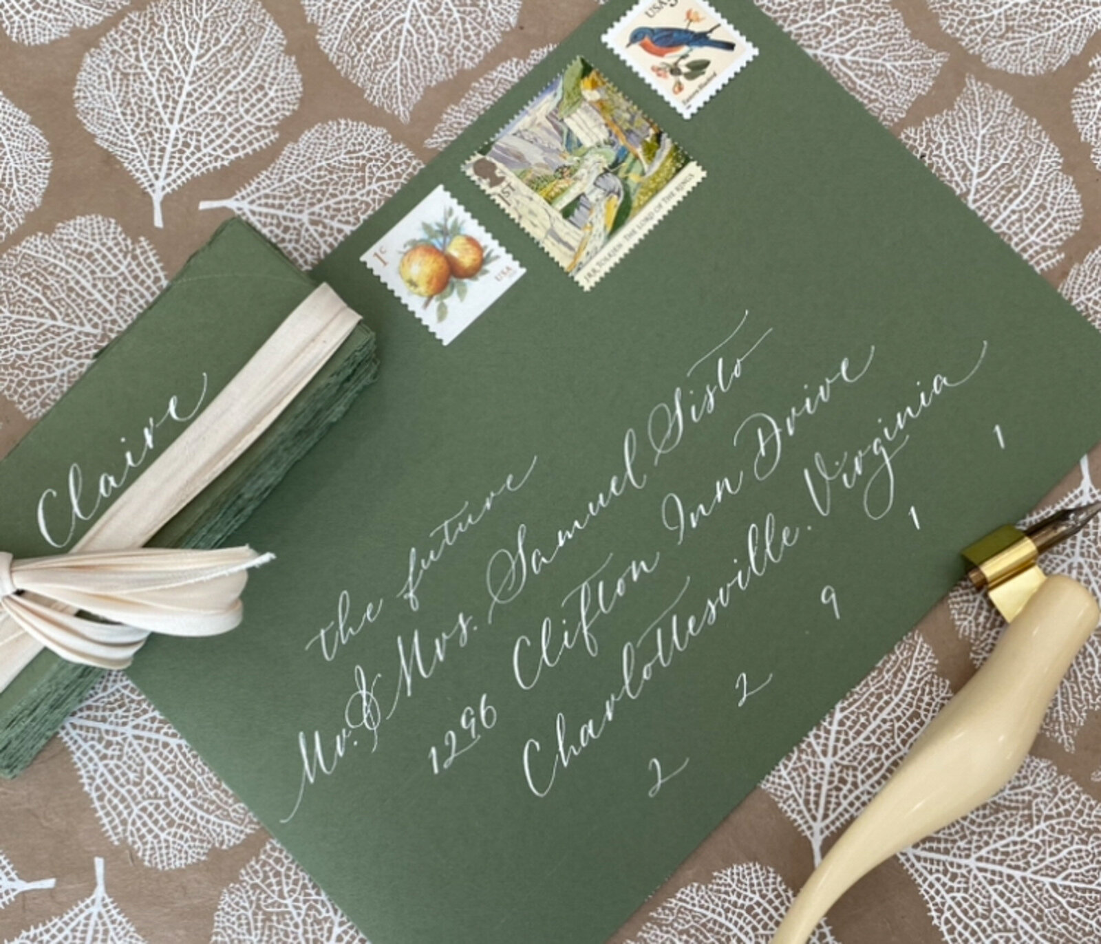Green envelope with custom calligraphy and stamps