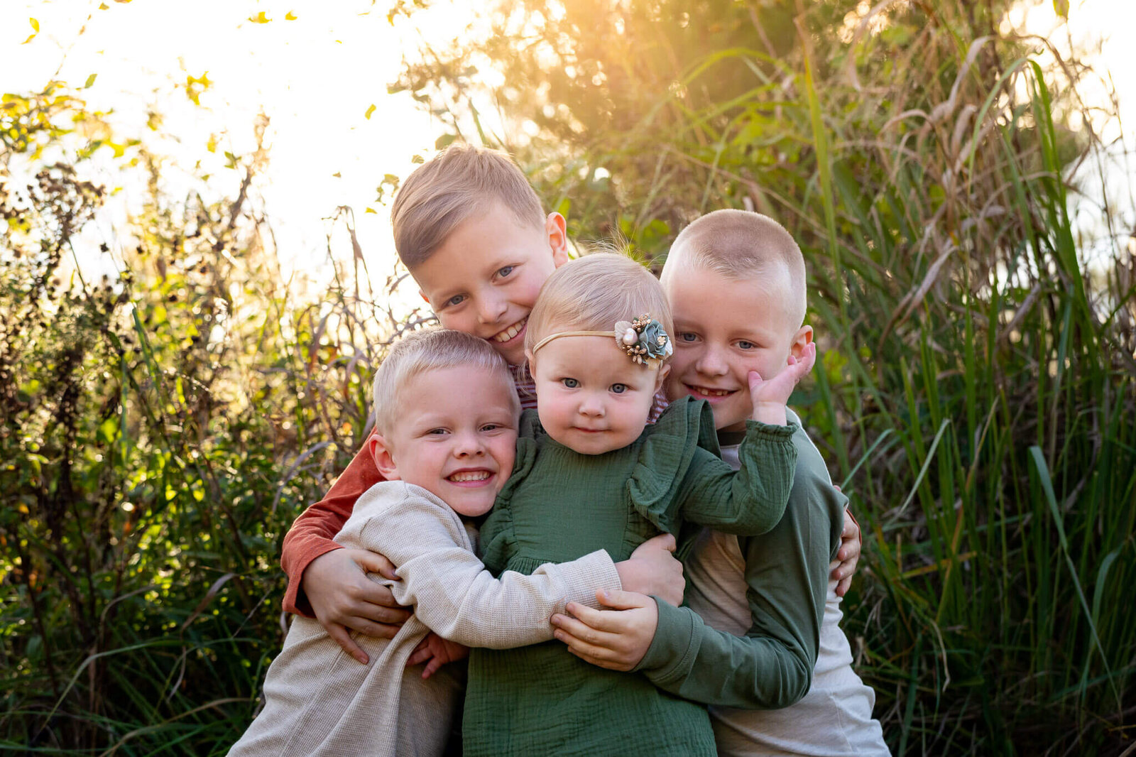 Four siblings snuggling during a Northern Virginia family photo session.