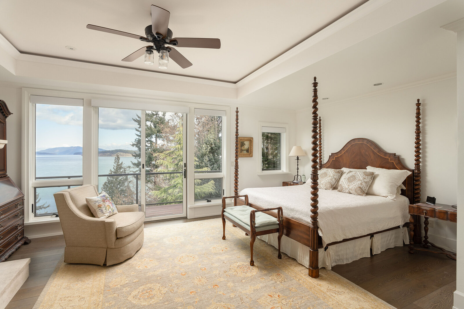 primary bedroom with floor to ceiling windows with an ocean view