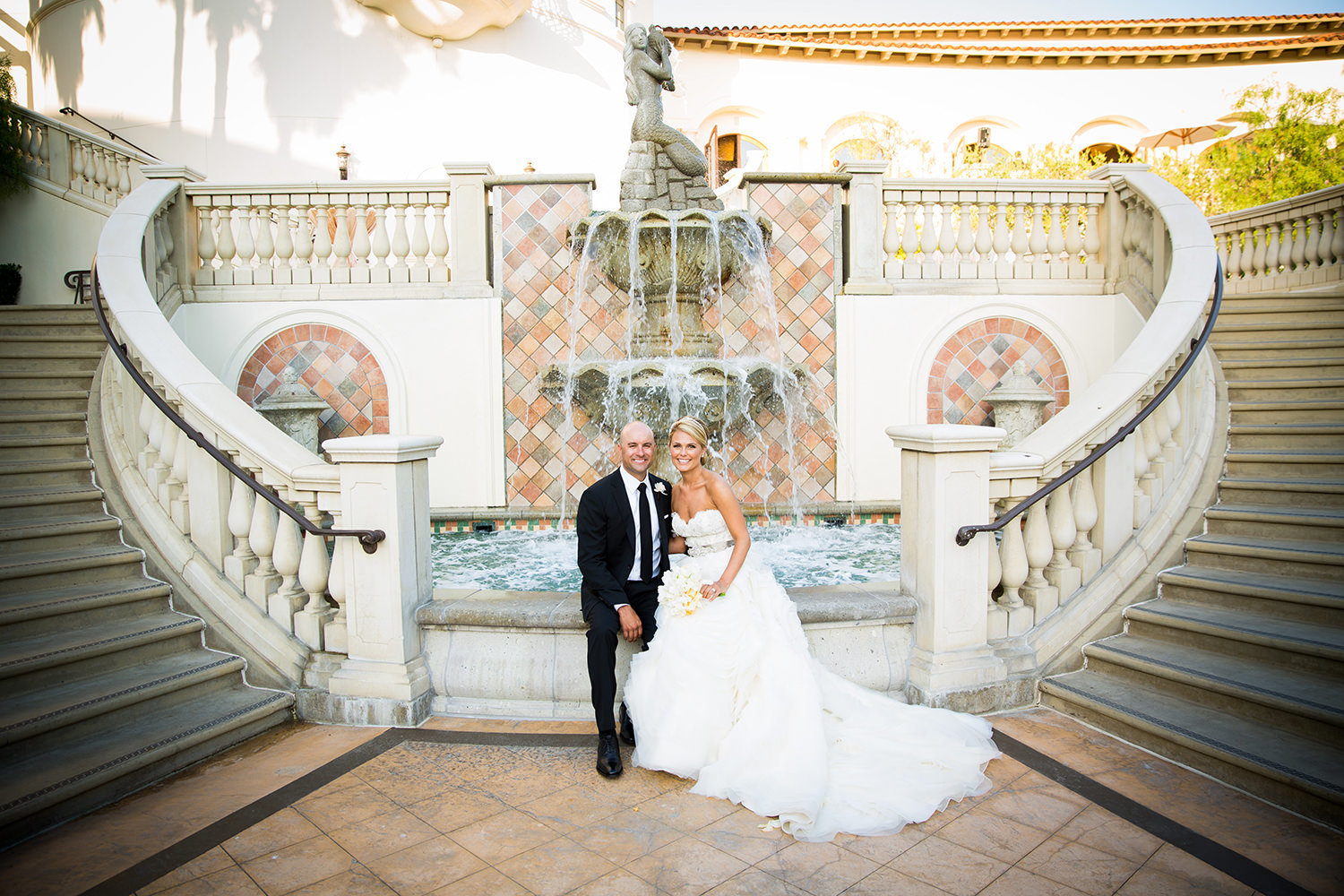 The water fountain between the staircases sets the perfect scene for this romantic portrait