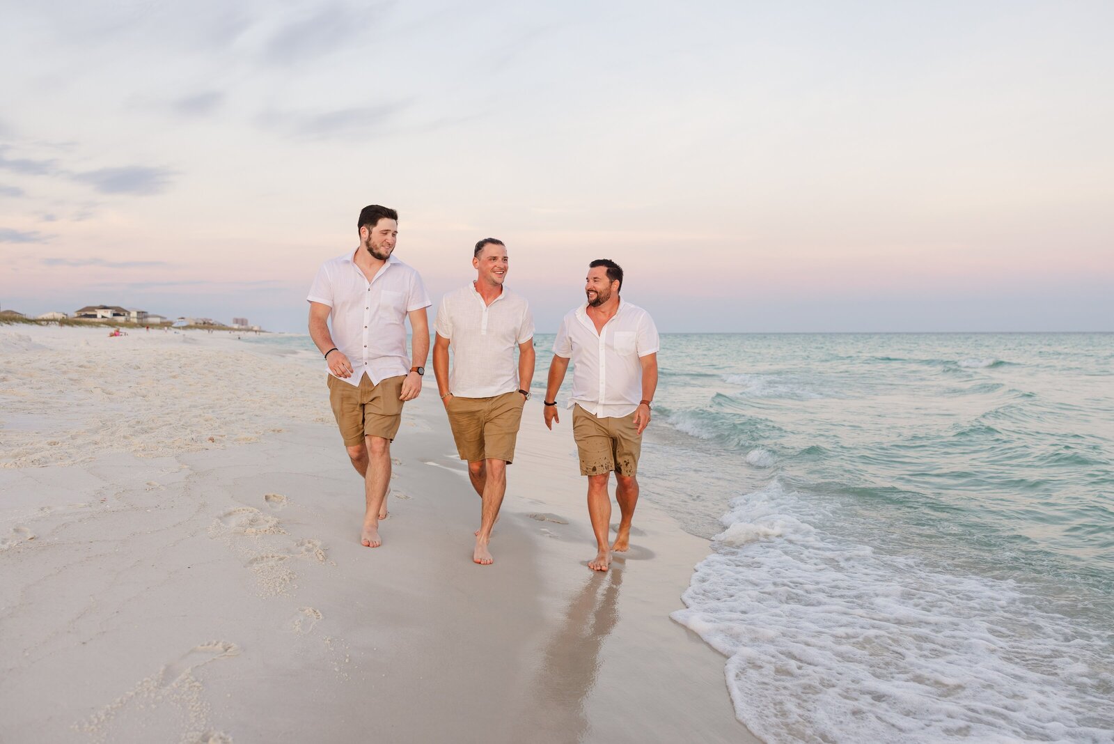 Three adult sons walking down beach at sunset during beach trip photos by Jennifer Beal Photography