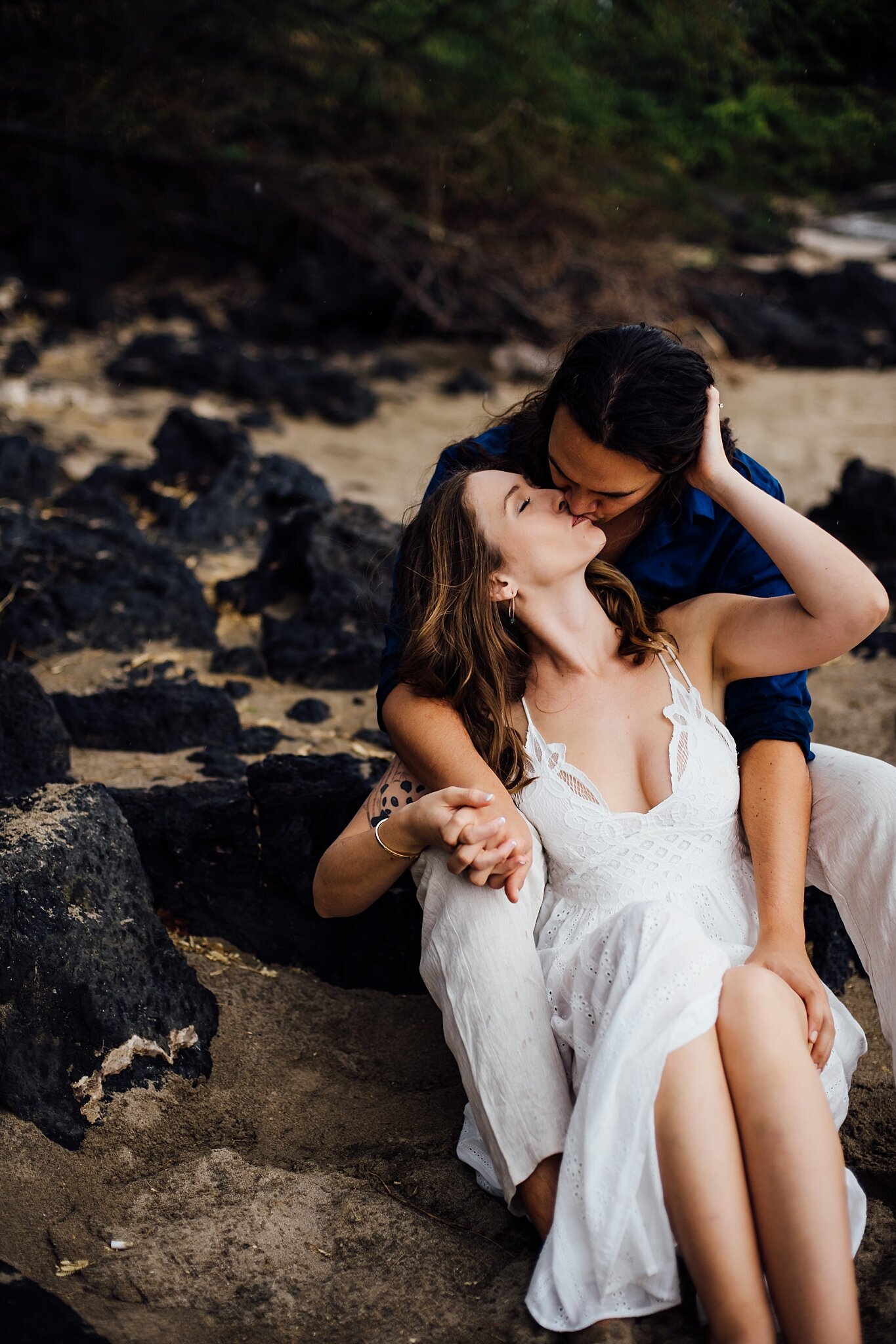 newly engaged couple kissing in a hawaii beach