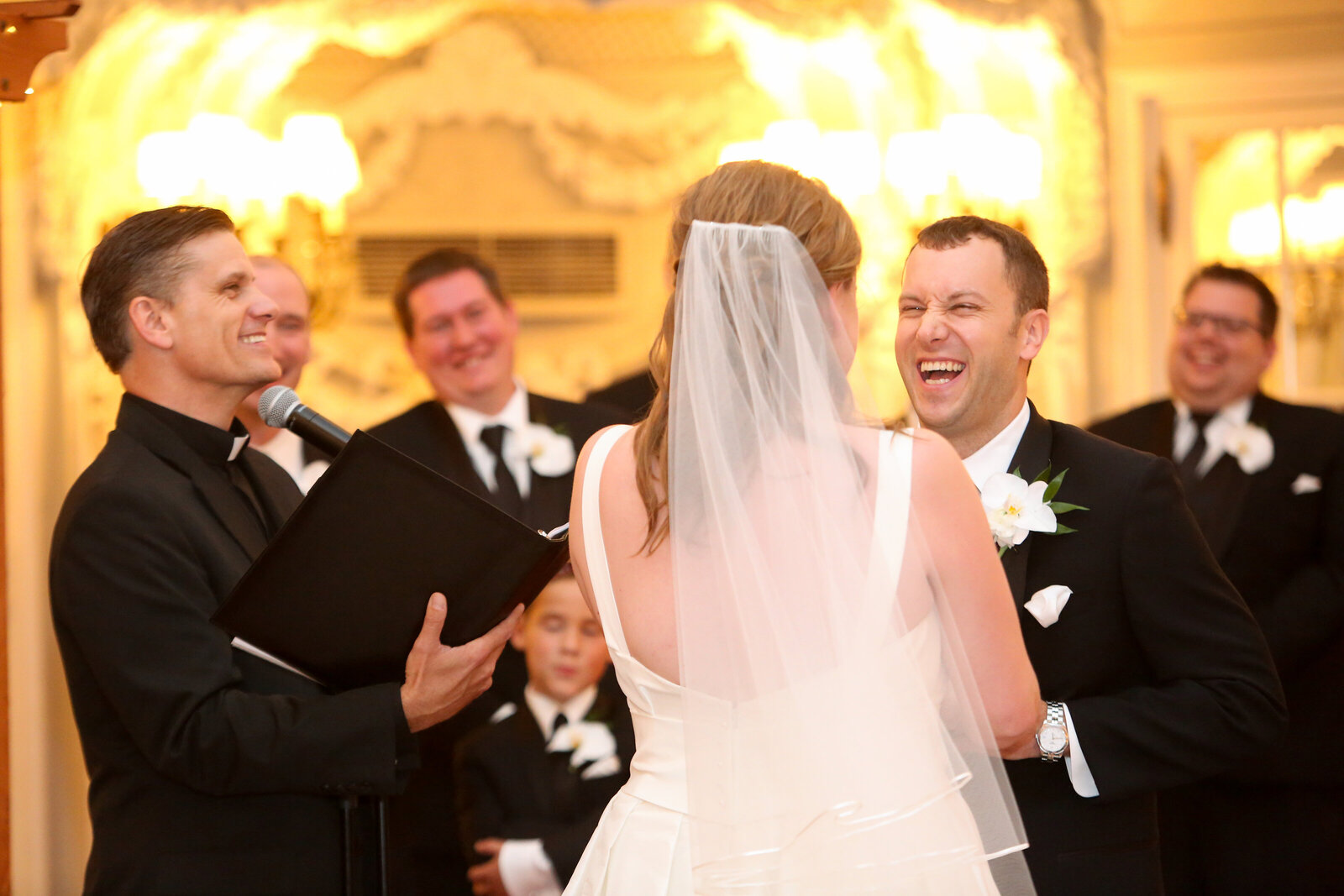 Groom laughs during wedding ceremony