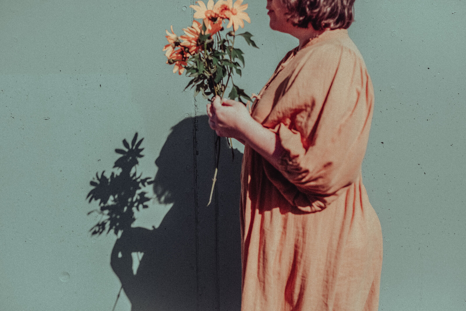 Woman posing with flowers in a branding photography session