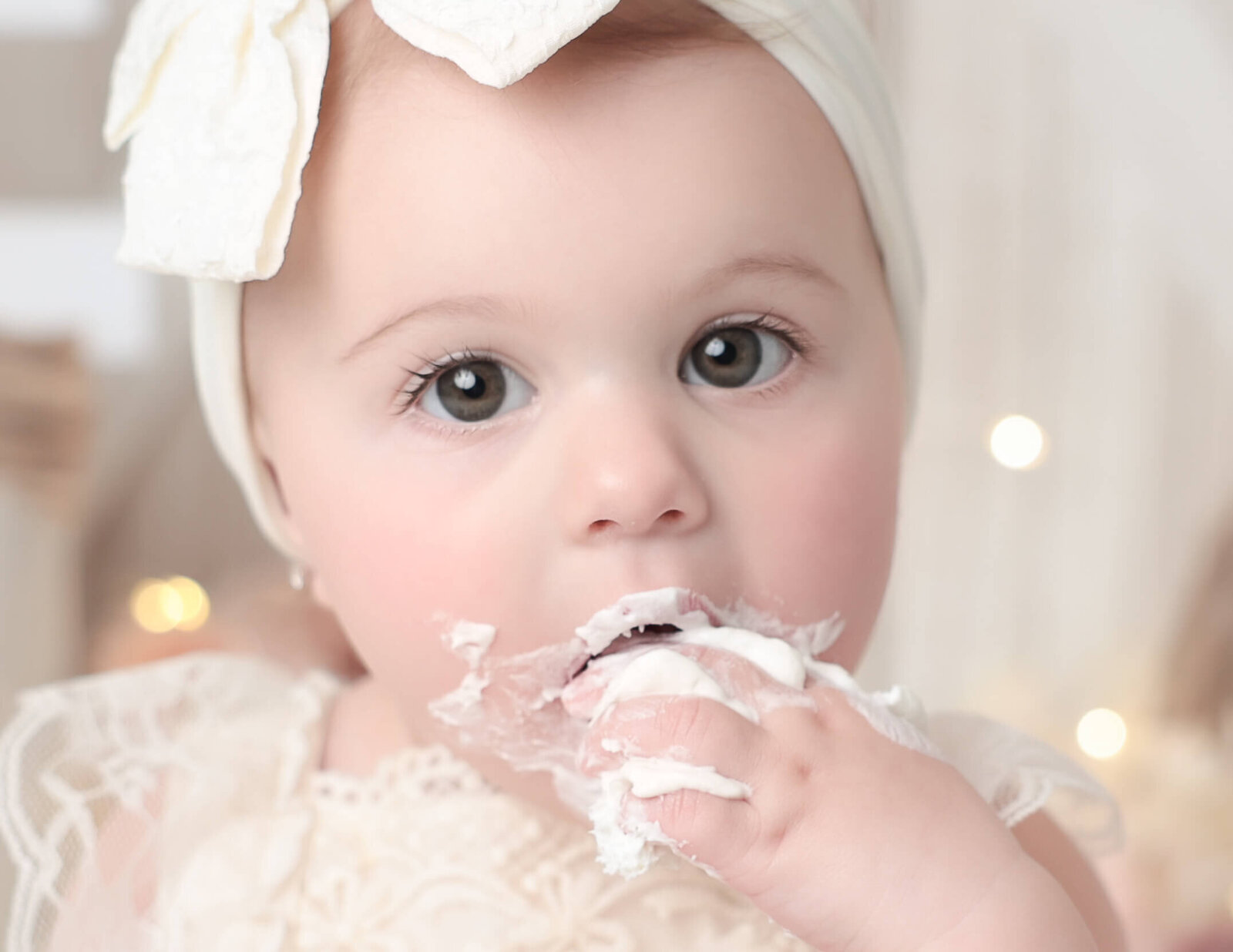 Close up of cute girl eating cake at our in-home Rochester, Ny studio.