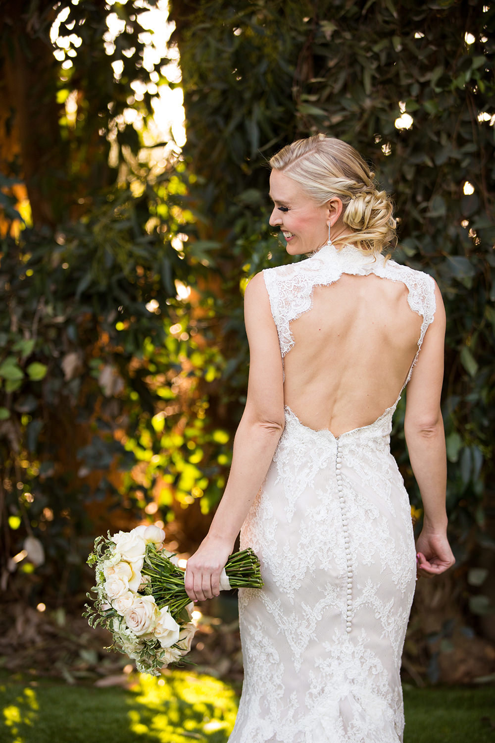 Incredible back of the dress portrait of beautiful bride