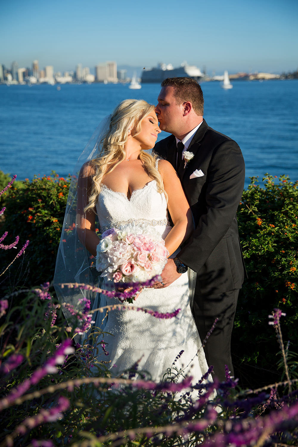 bride and groom with san diego skyline in background