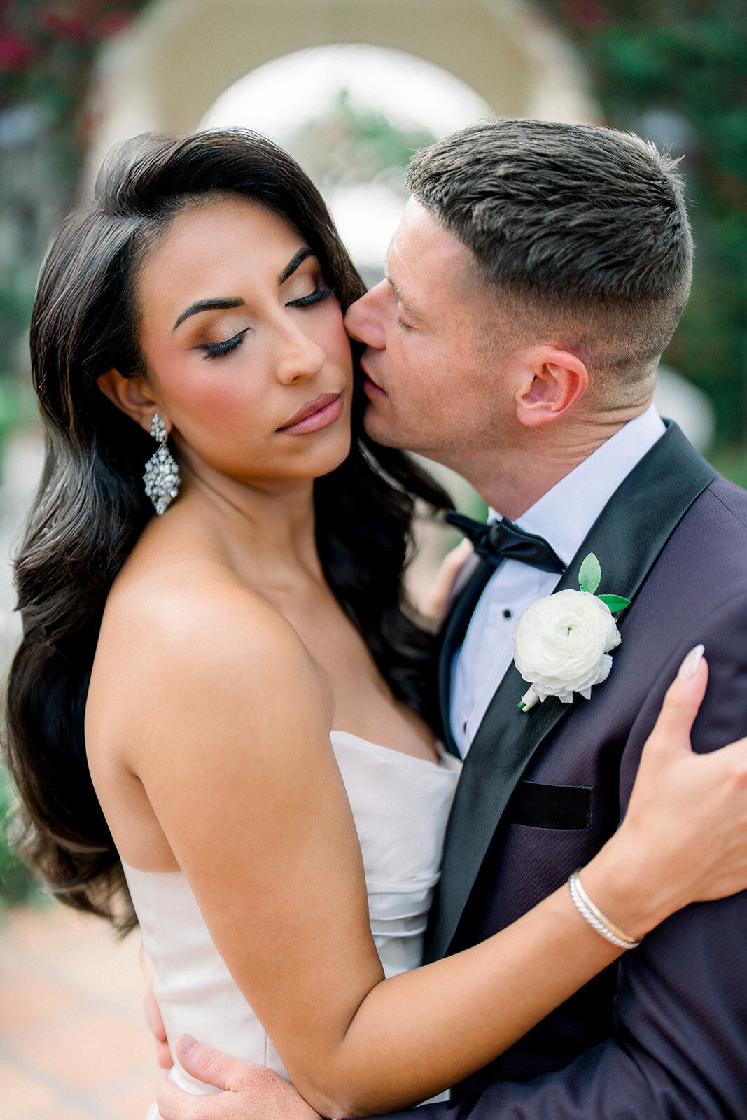 Bride and groom embrace with soft smiles in golden hour light, captured in fine art wedding photography in Simi Valley.