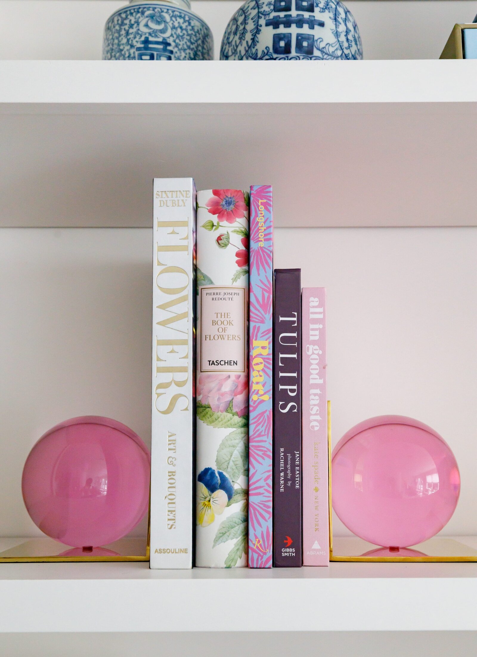 vision and hammer styling shelf with pink ball bookends and books