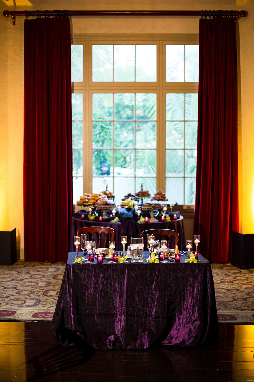 purple tables with lots of candles don room