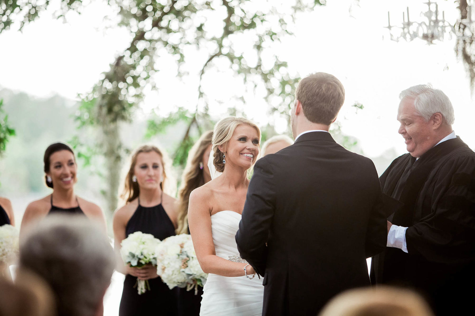 Bride and groom exchange vows under an oak tree, Dunes West Golf and River Club, Mt Pleasant, South Carolina. Kate Timbers Photography.