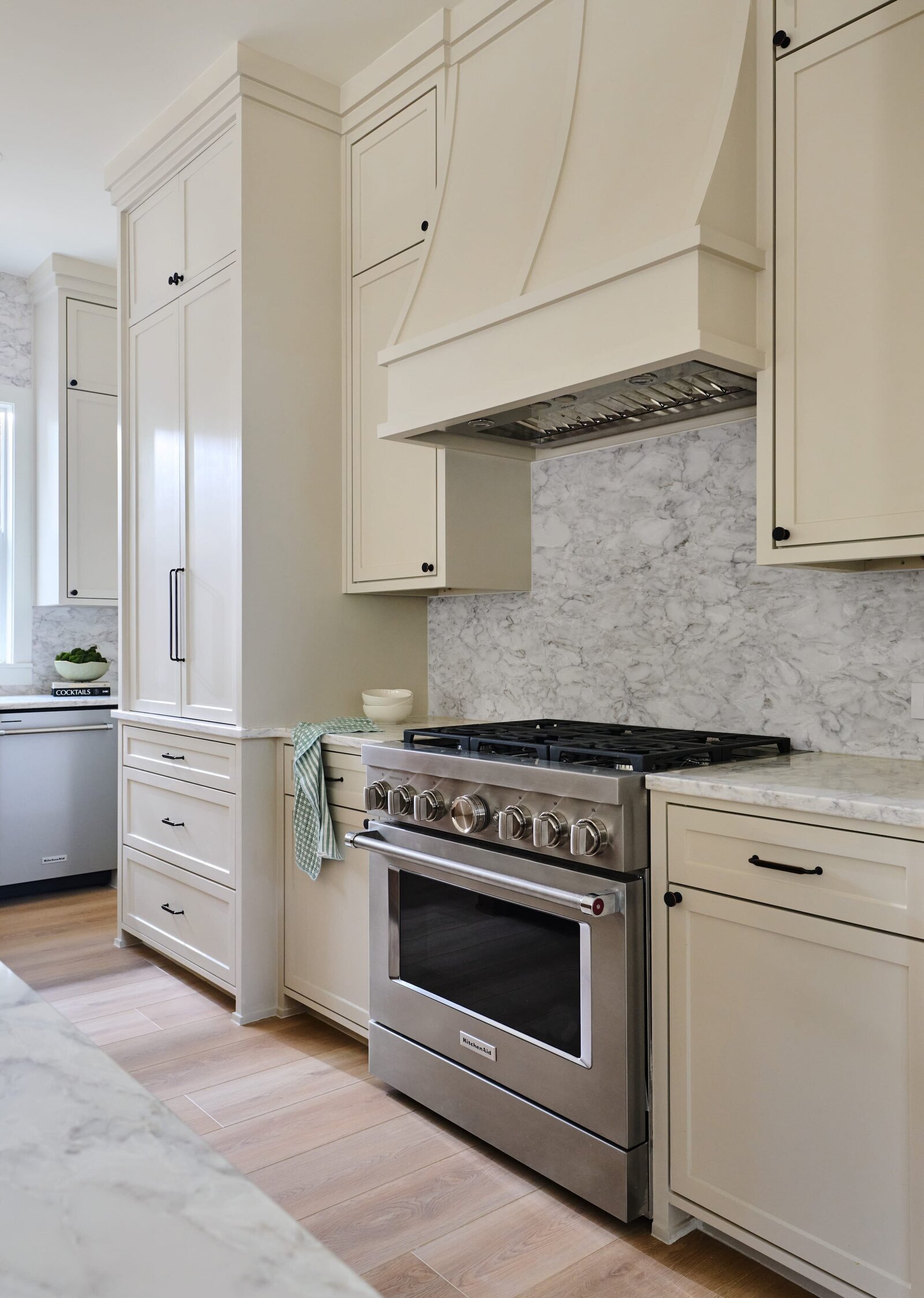 cocoloba homes graham classic kitchen with white cabinets and light wood flooring