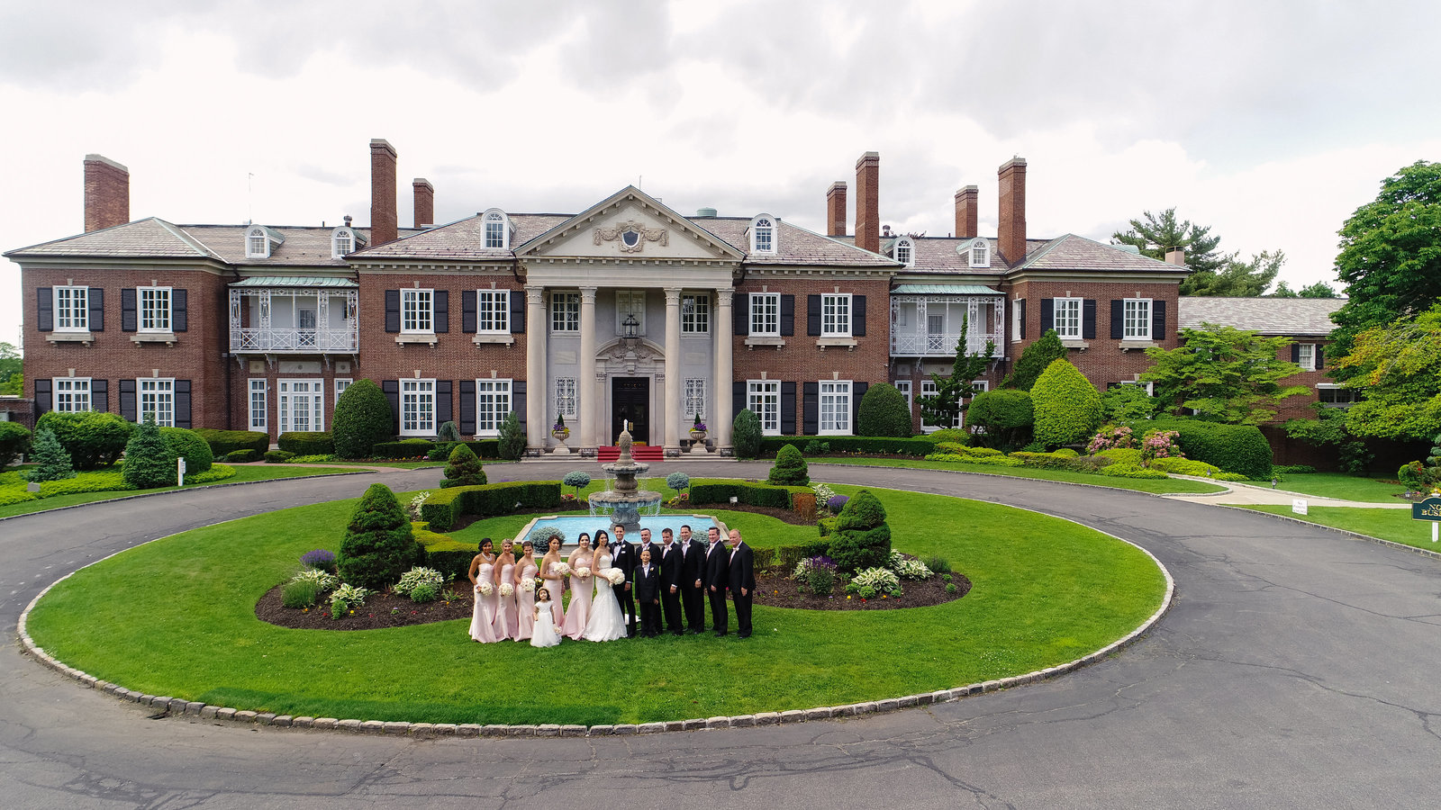 drone photo of the bridal party at Glen Cove Mansion