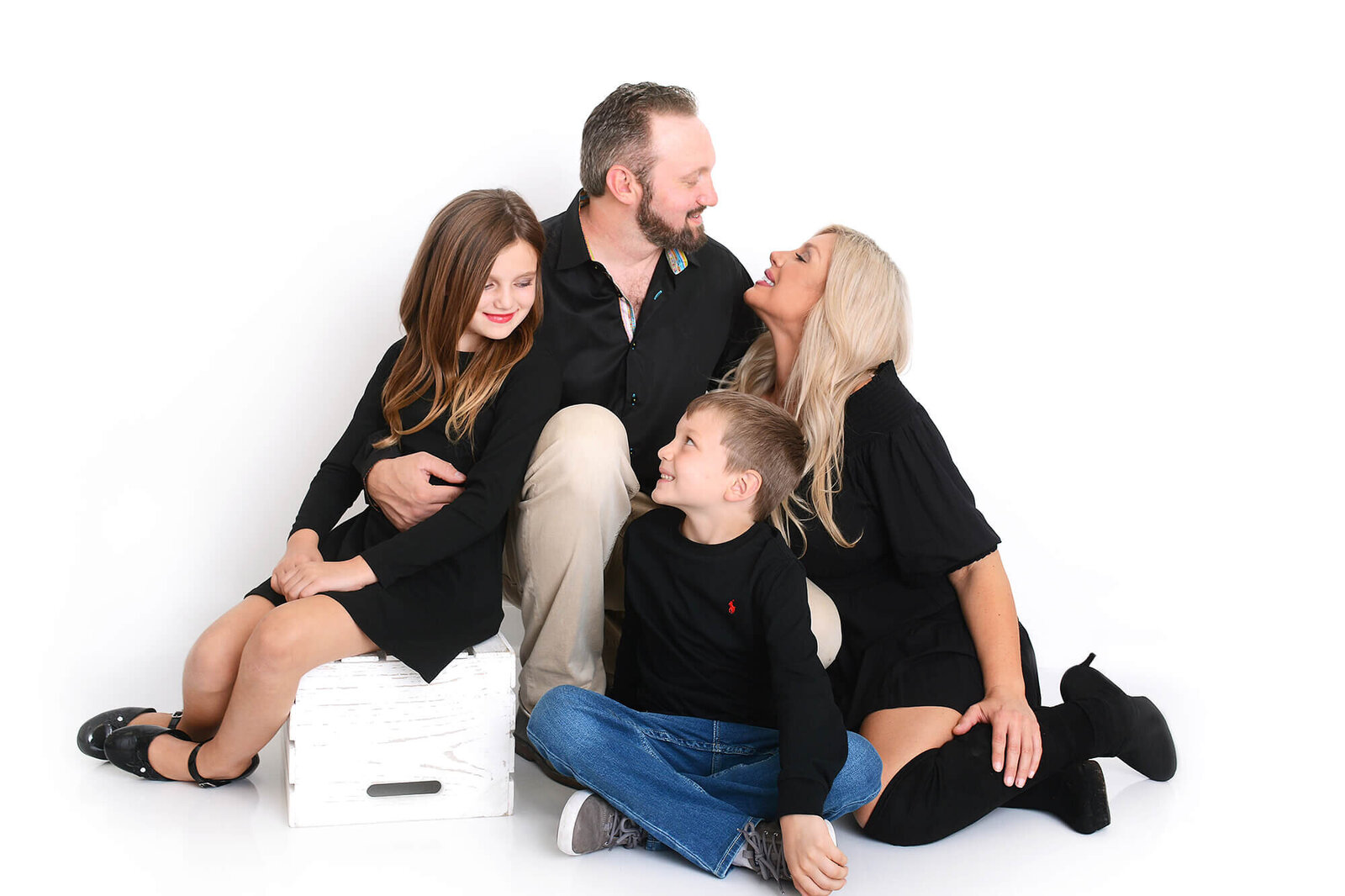 family smiles at eachother at their photoshoot