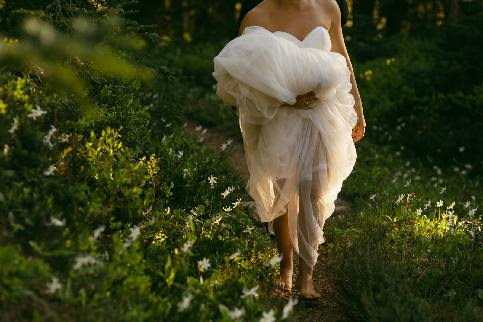 bride walking in wildflowers