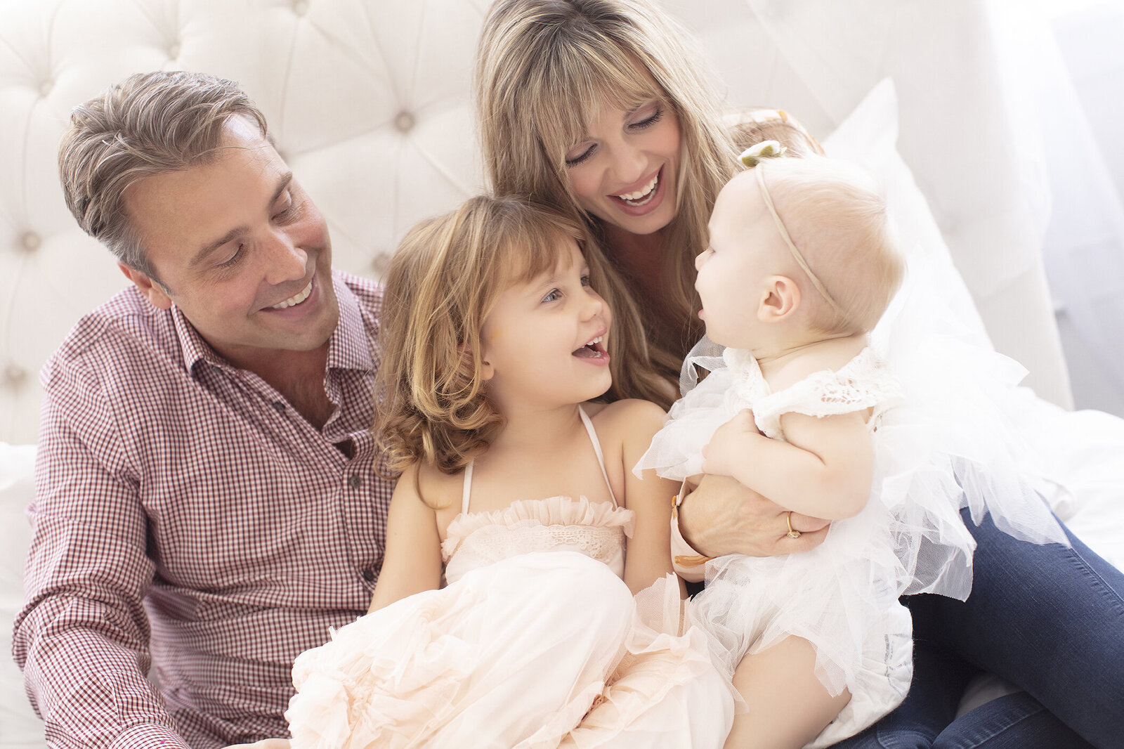 Plano Family laughing with baby at indoor photography studio