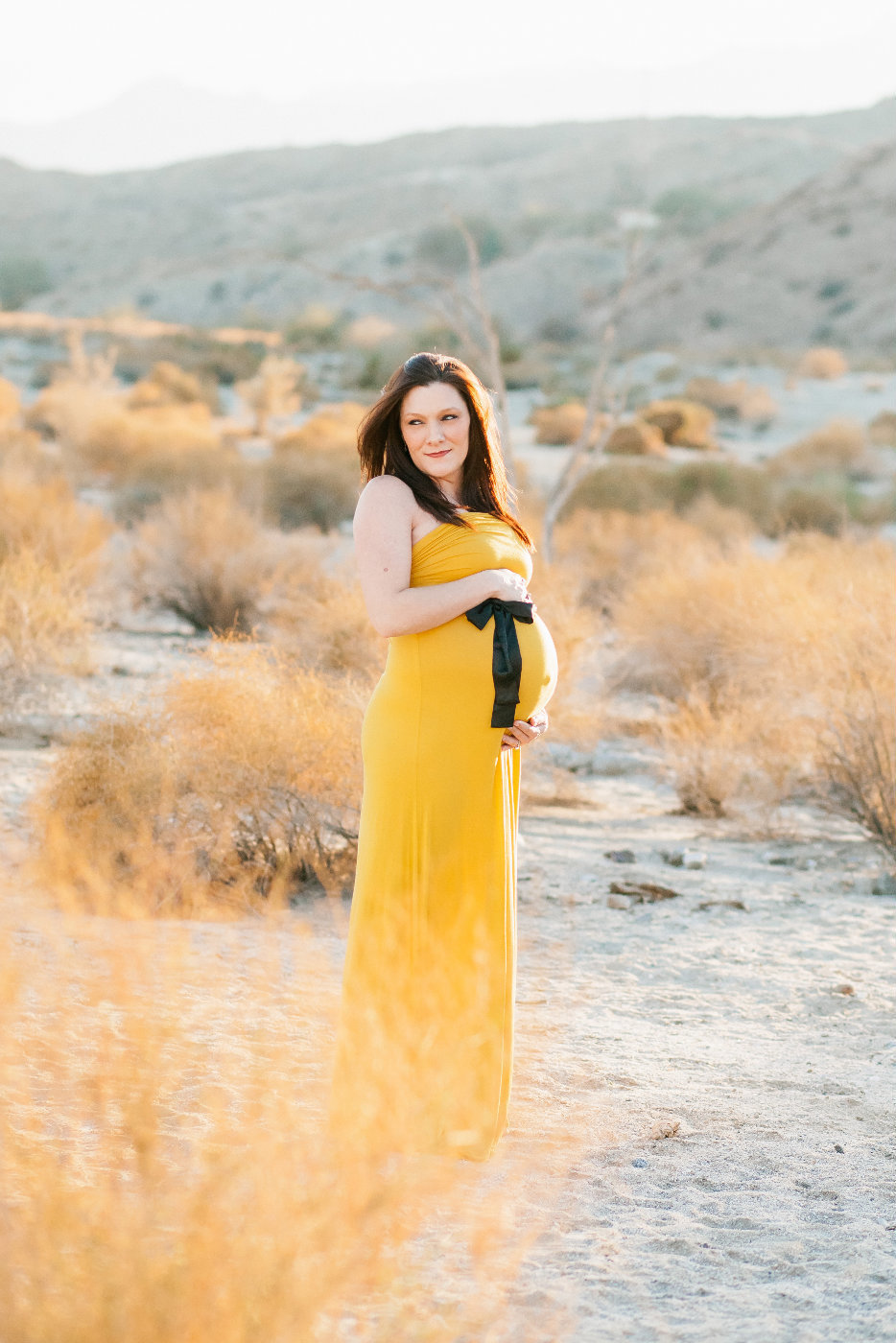 Maternity session mom in yellow dress in Palm Desert CA