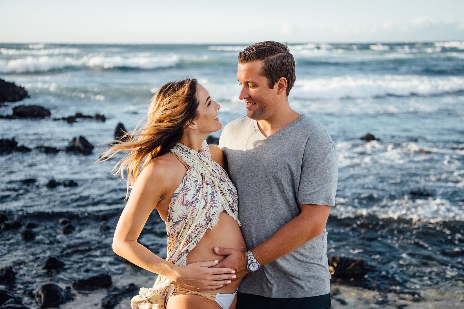 couple looking at each other during their babymoon session