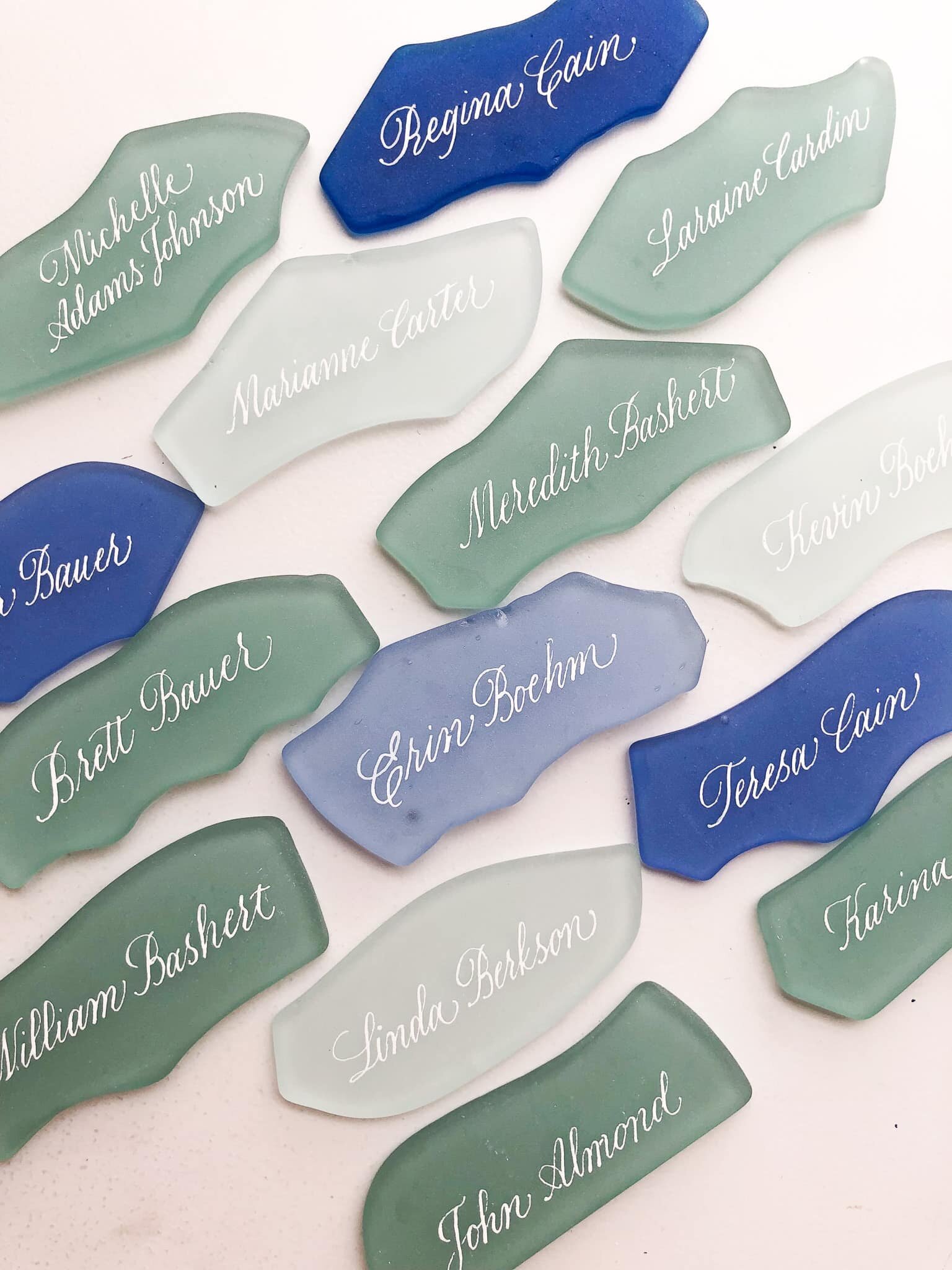 set of sea glass place cards with name calligraphy