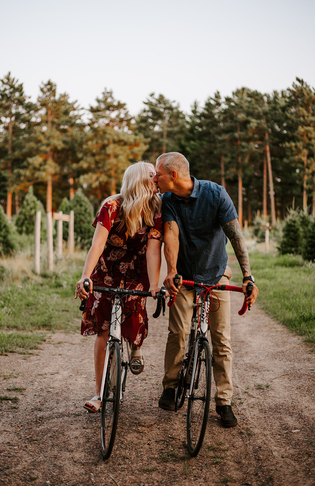 Couple riding bikes and sharing a kiss during their Minneapoolis engagement session