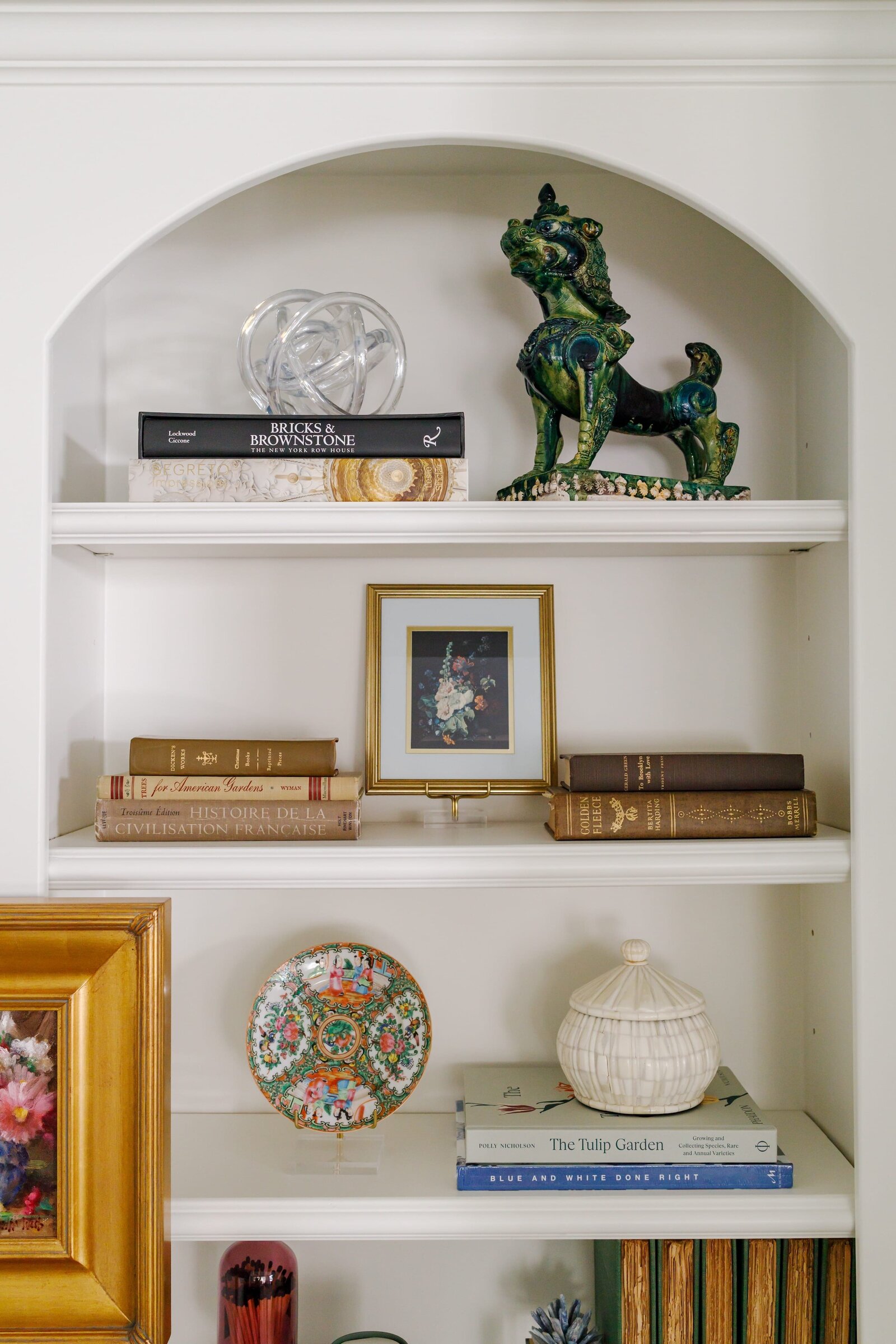 vision and hammer styling shelf with books and gold picture frame