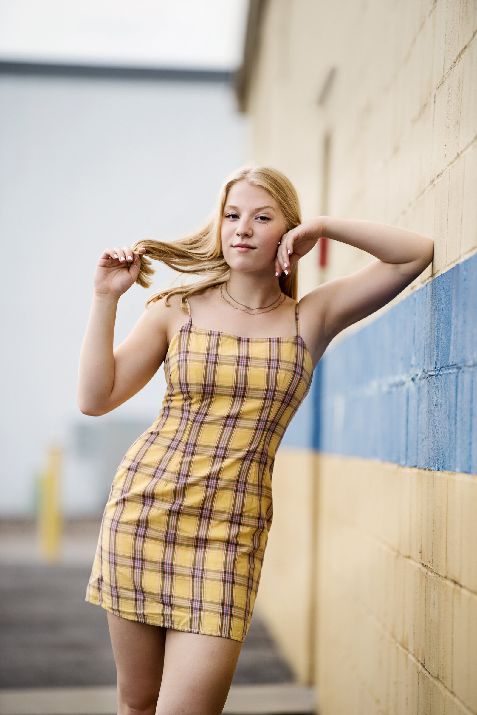 Excelsior Minnesota high school senior picture of girl in yellow plaid dress in urban setting