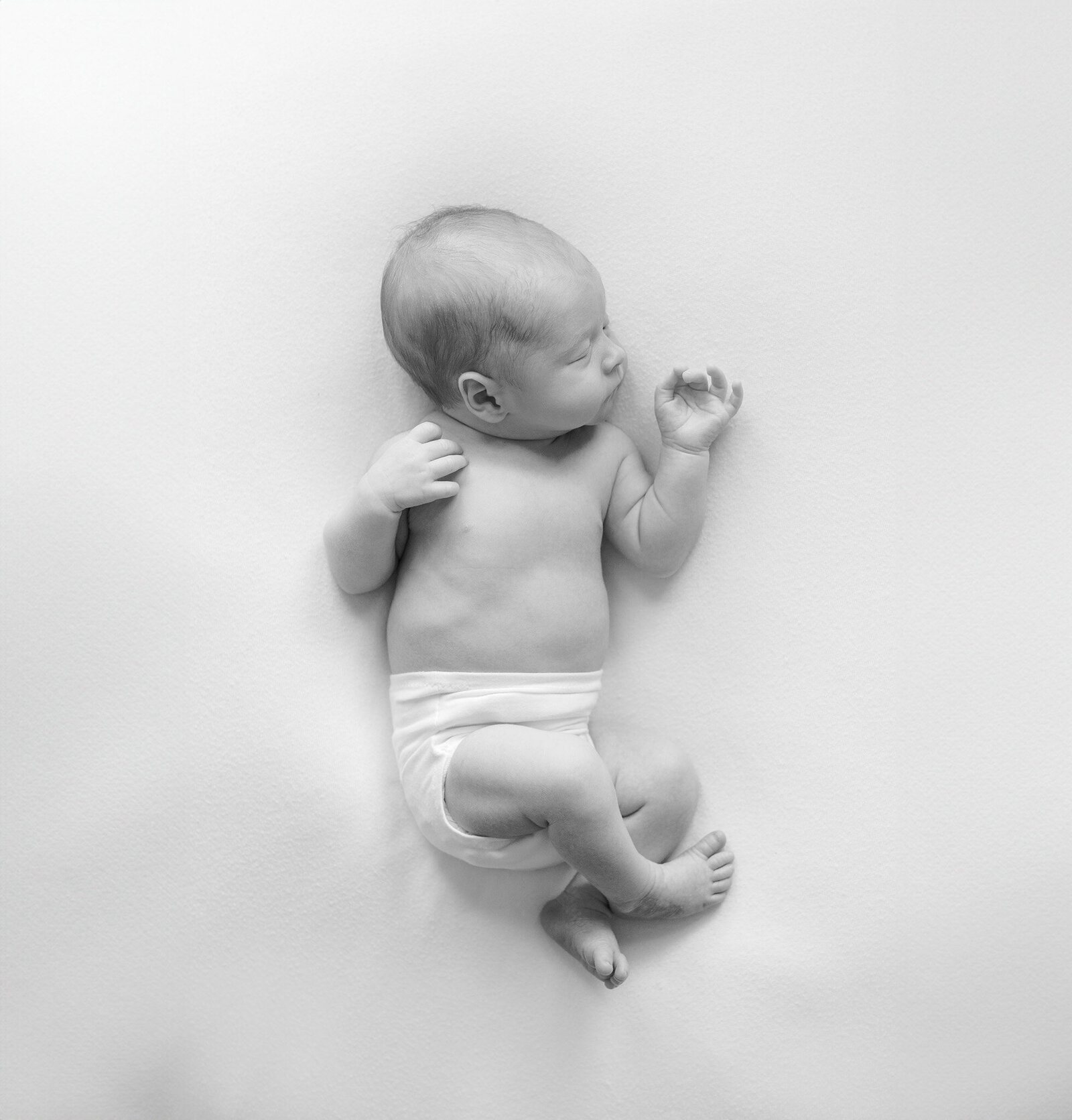 baby wearing simple diaper cover sleeps during massachusetts newborn photoshoot