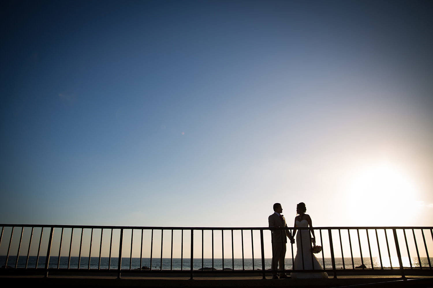 bride and groom romantic image at coronado community center sunset