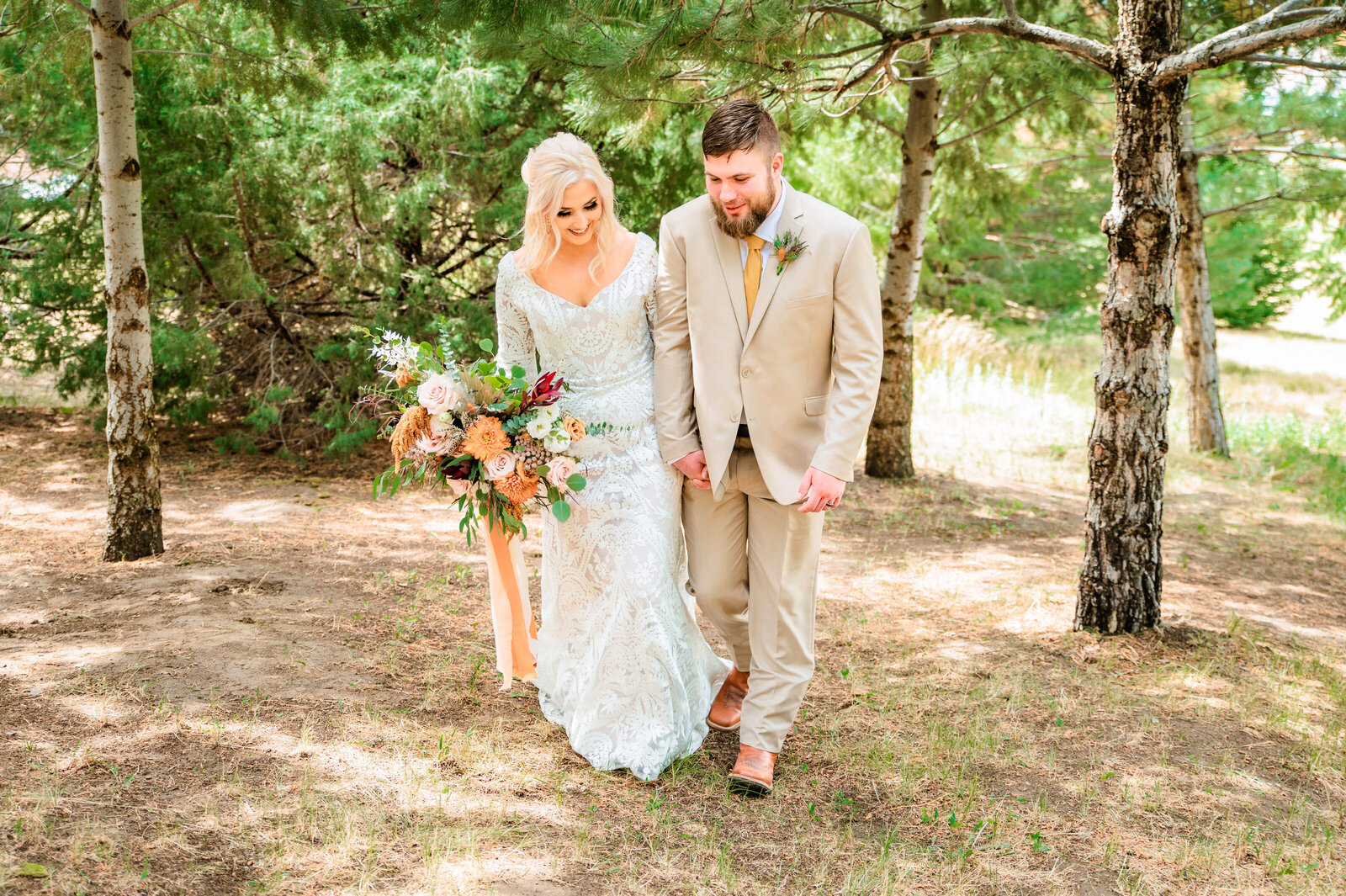 Jackson Hole photographers capture bride and groom walking together after Grand Teton wedding