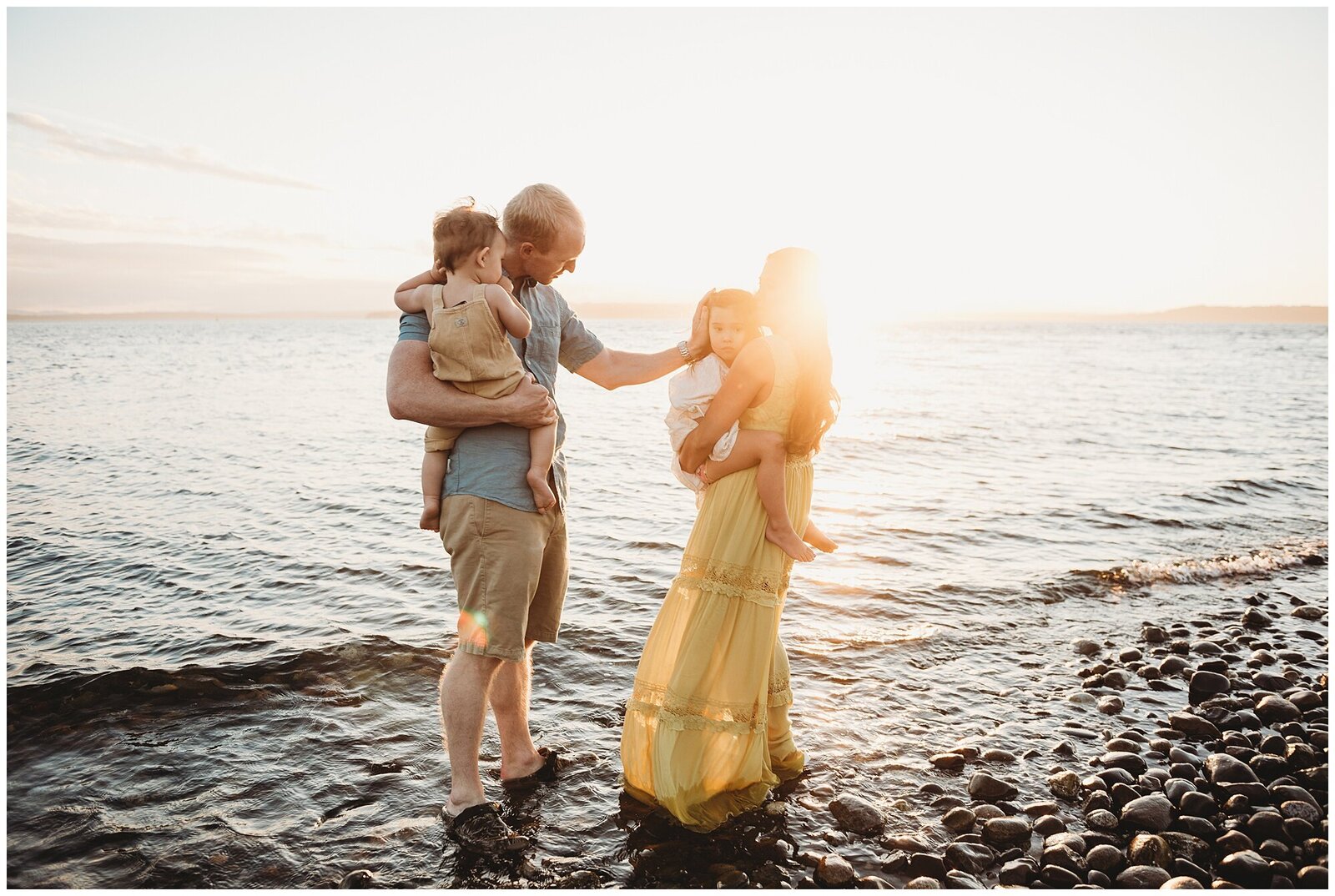 Family of 4 in water on beach at sunset Emily Ann Photography Seattle Photographer