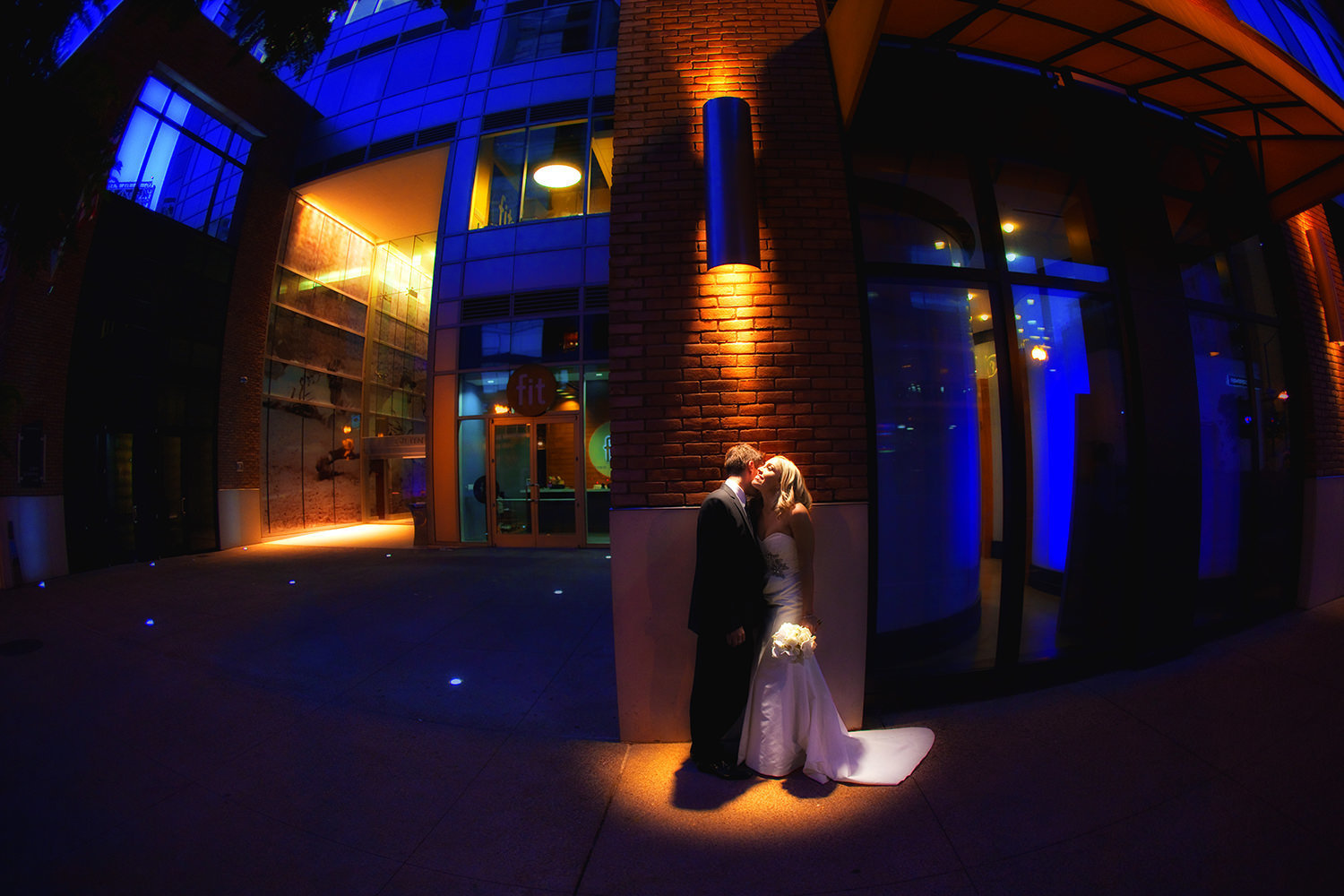 Awesome night time portrait of wedding couple downtown