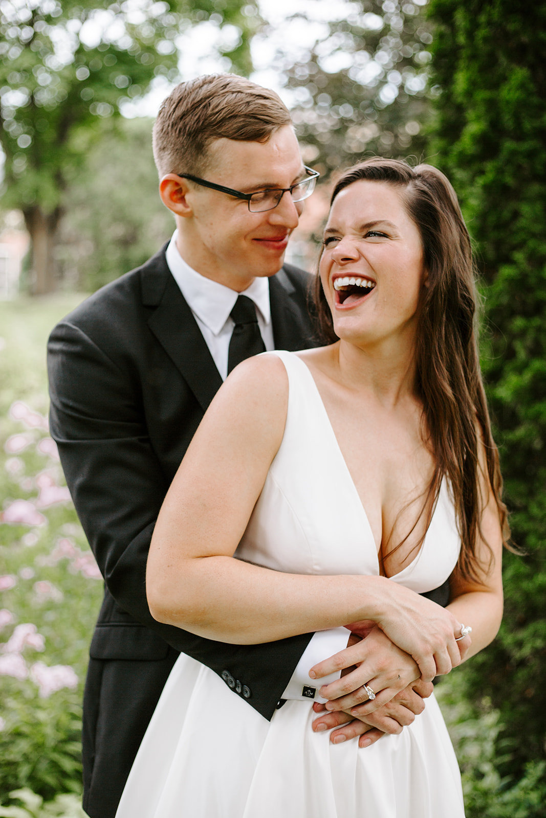 Bride and groom smiling and laughing at each other during their Minneapolis wedding day