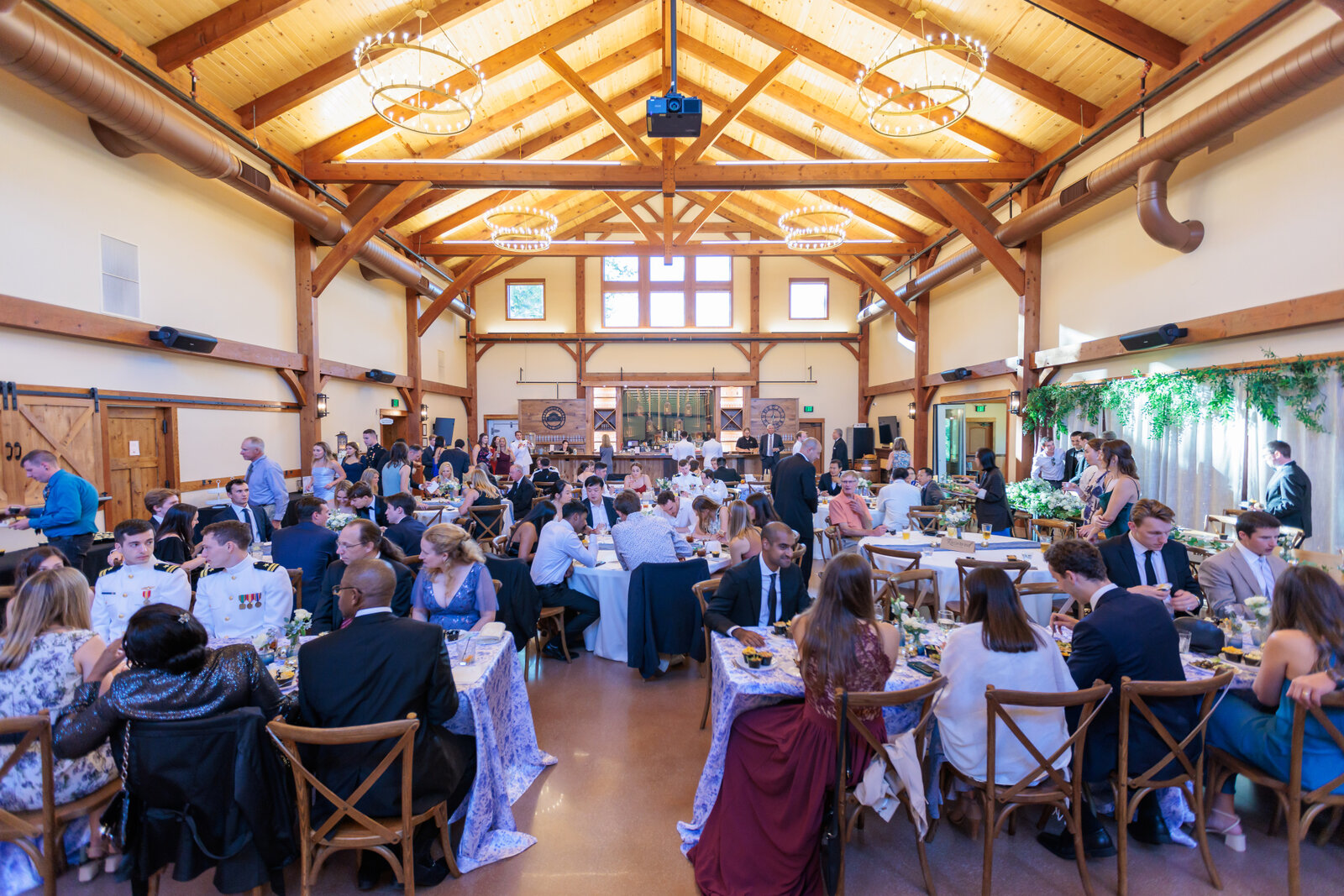 wedding guests during a wedding reception in the barn at barnwood events in madison, winconsin.