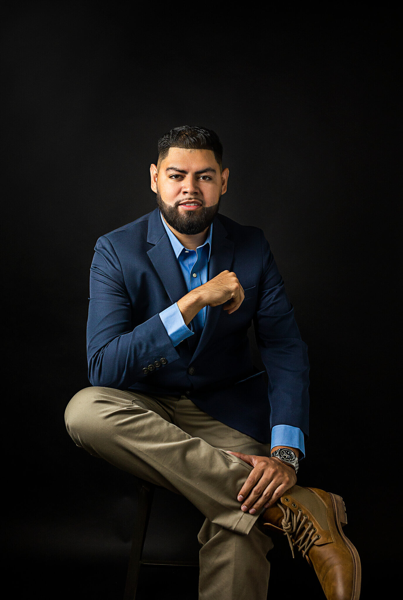 Man posing with a blue jacket and expensive watch for a brabding photoshoot in Austin