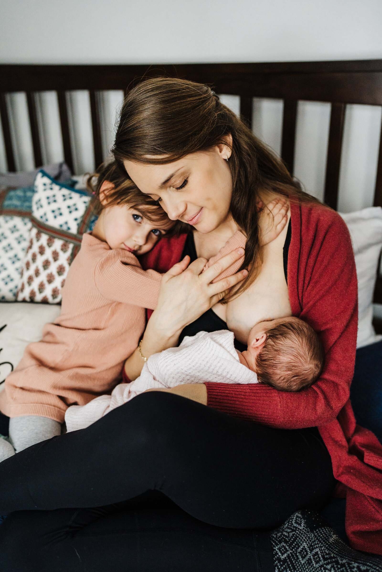 mom nurses baby and snuggles toddler during boston newborn session