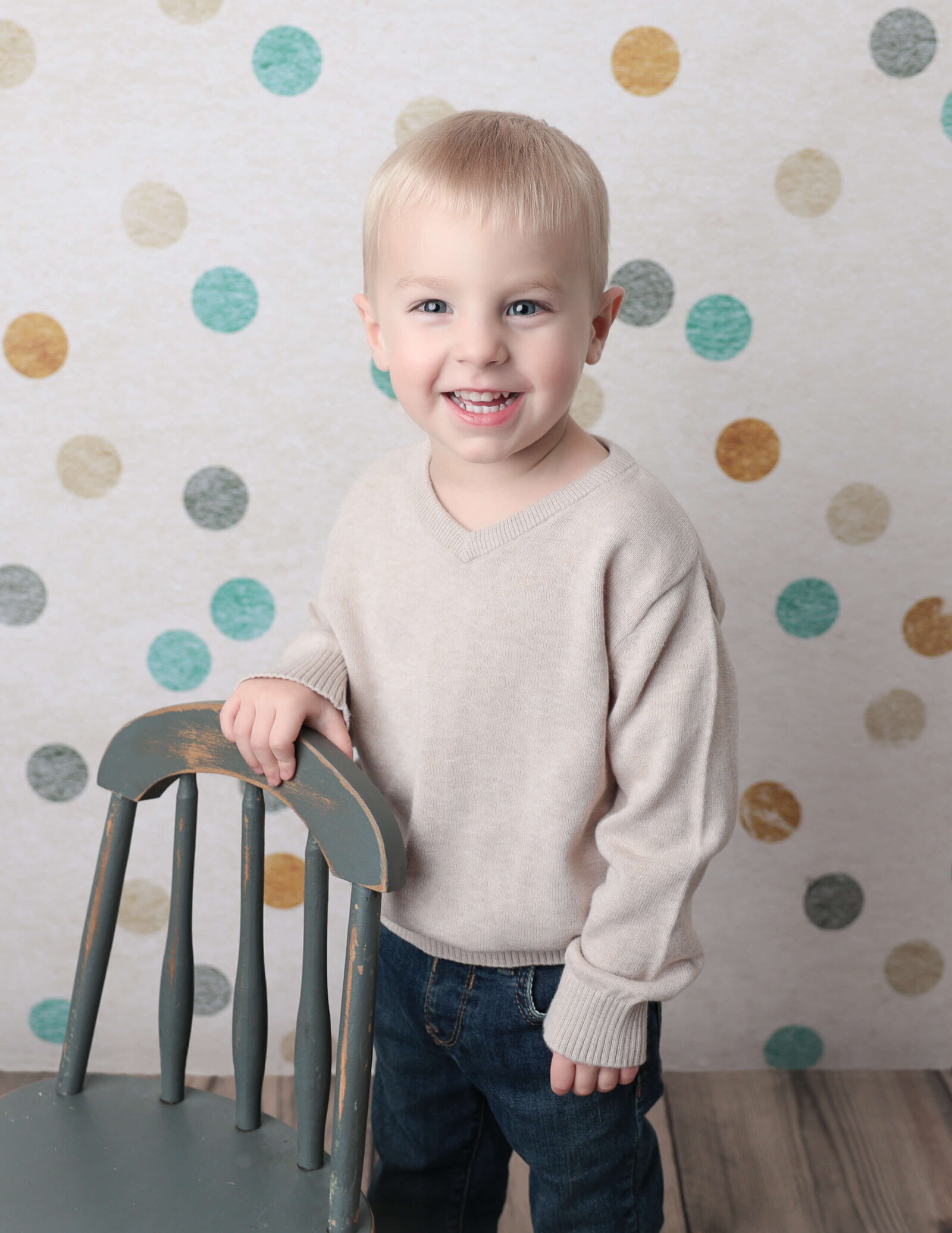 Happy three year old boy posed at our studio in Rochester, Ny.