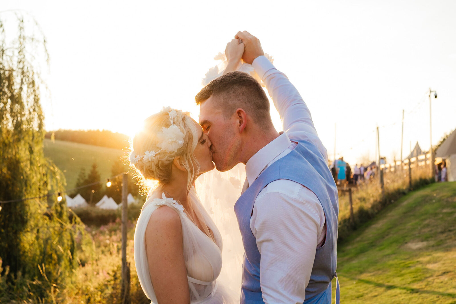 bride and groom kiss in golden light at their relaxed Devon wedding