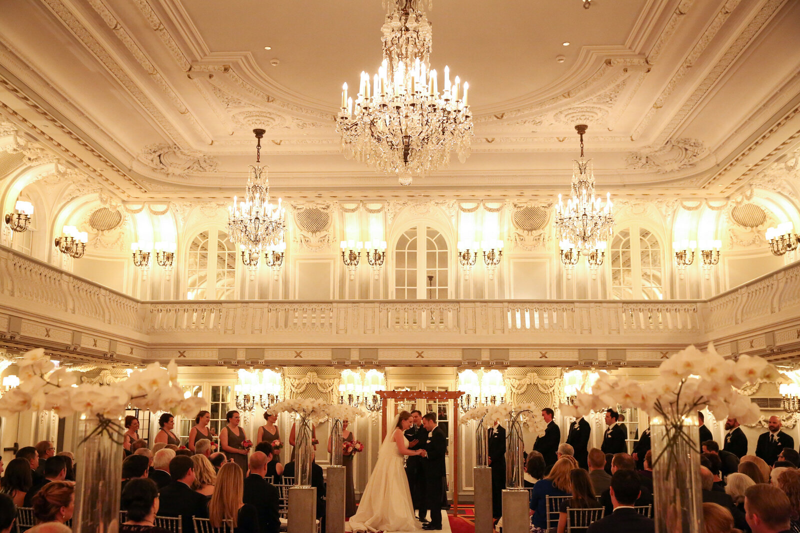 Bride and groom take their vows in grand ballroom