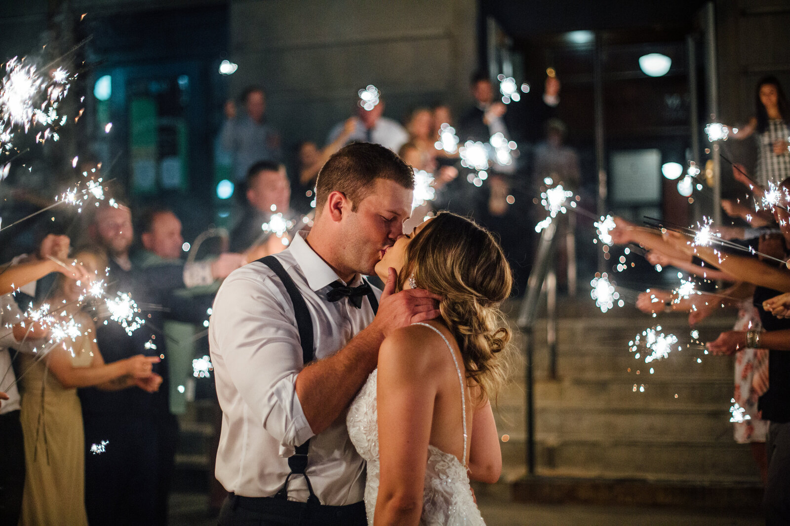 Bride and Groom kissing with fireworks