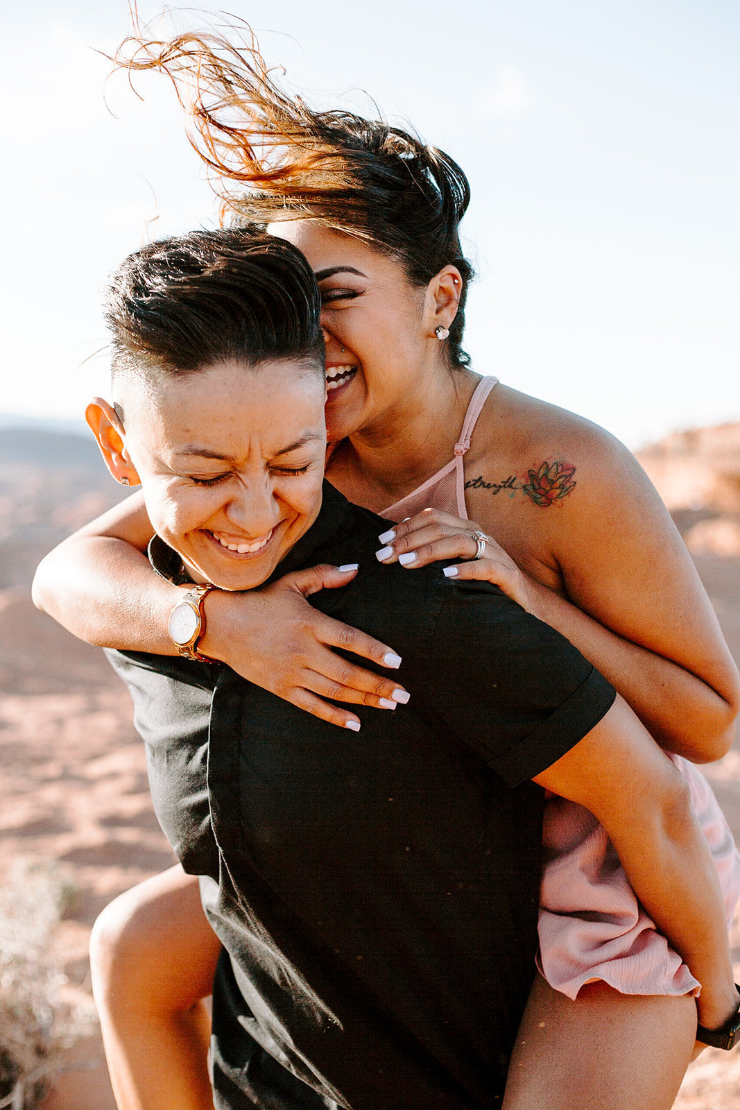 Couple doing a piggy back ride during their Arizona Engagement Session