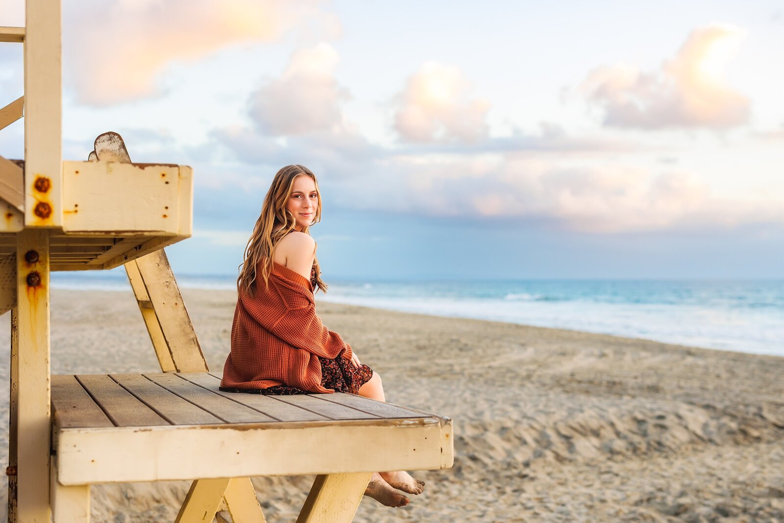 Girl sitting on life guard tower at Carlsbad State beach