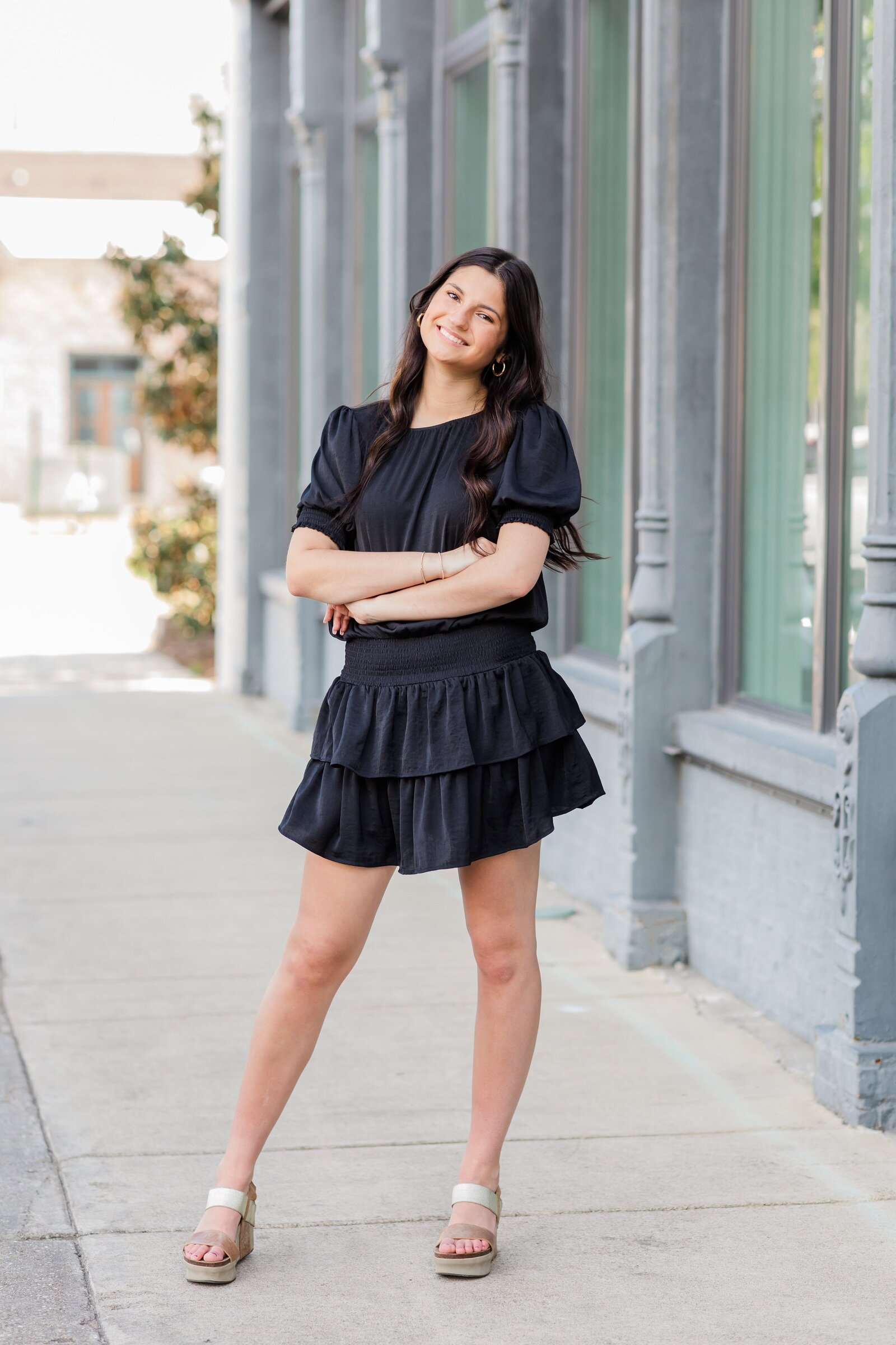 Senior girl posing in front of Five Eleven Palafox during photo session by Pensacola Photographers
