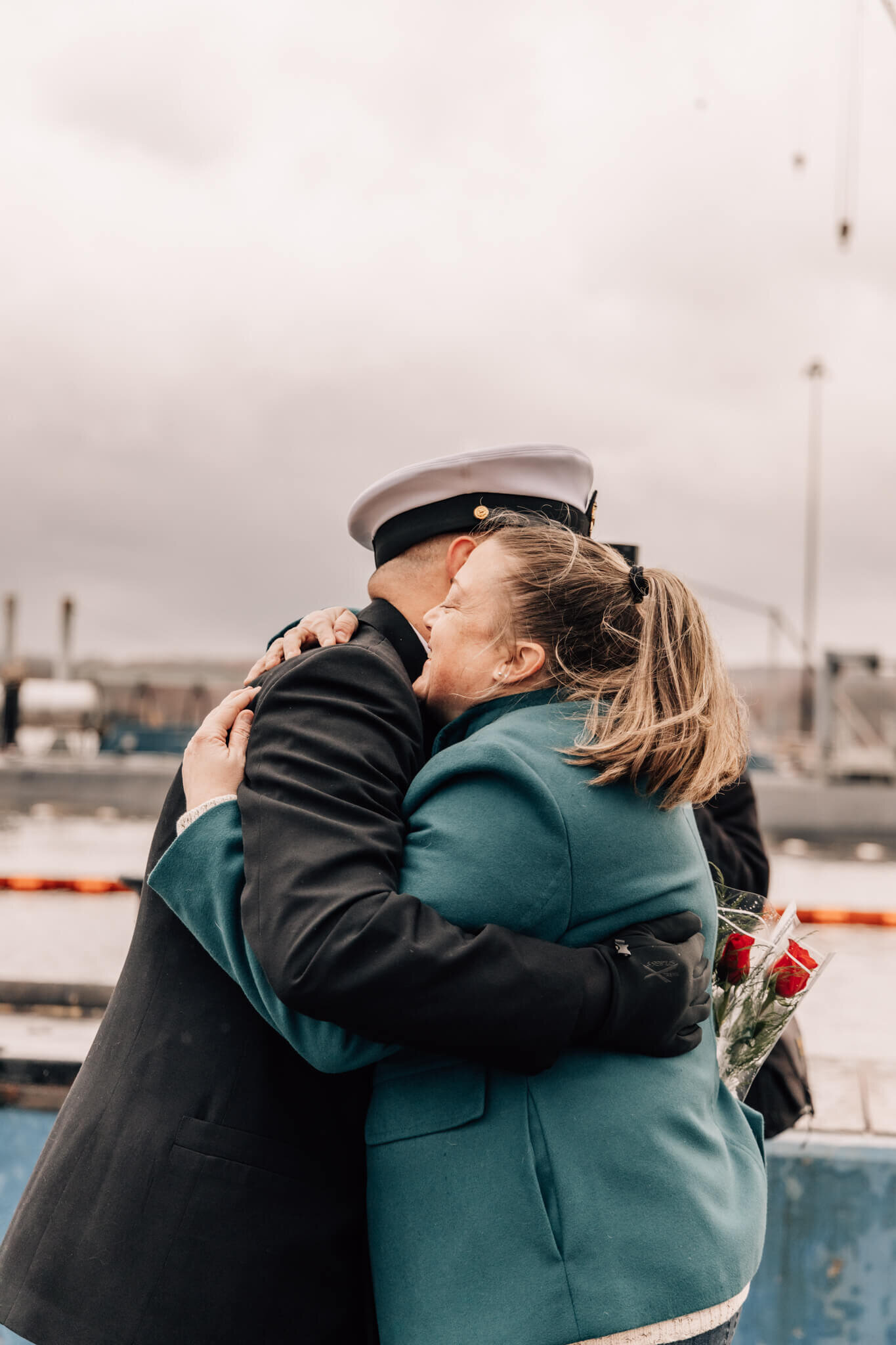 Chief petty officer hugs wife after returning from 6 month deployment on USS Minnesota.