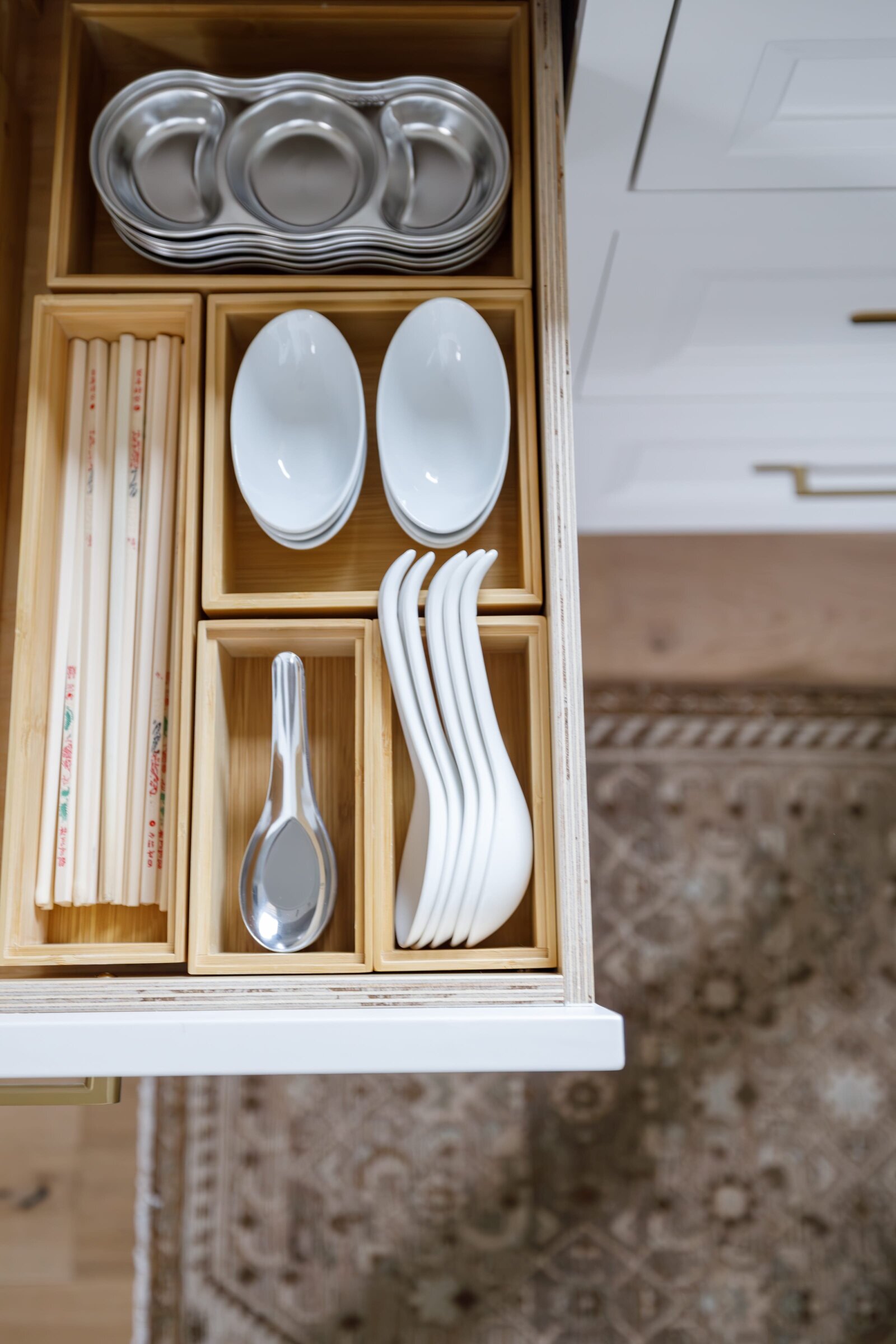 vision and hammer organizing kitchen drawer with spoons and chopsticks