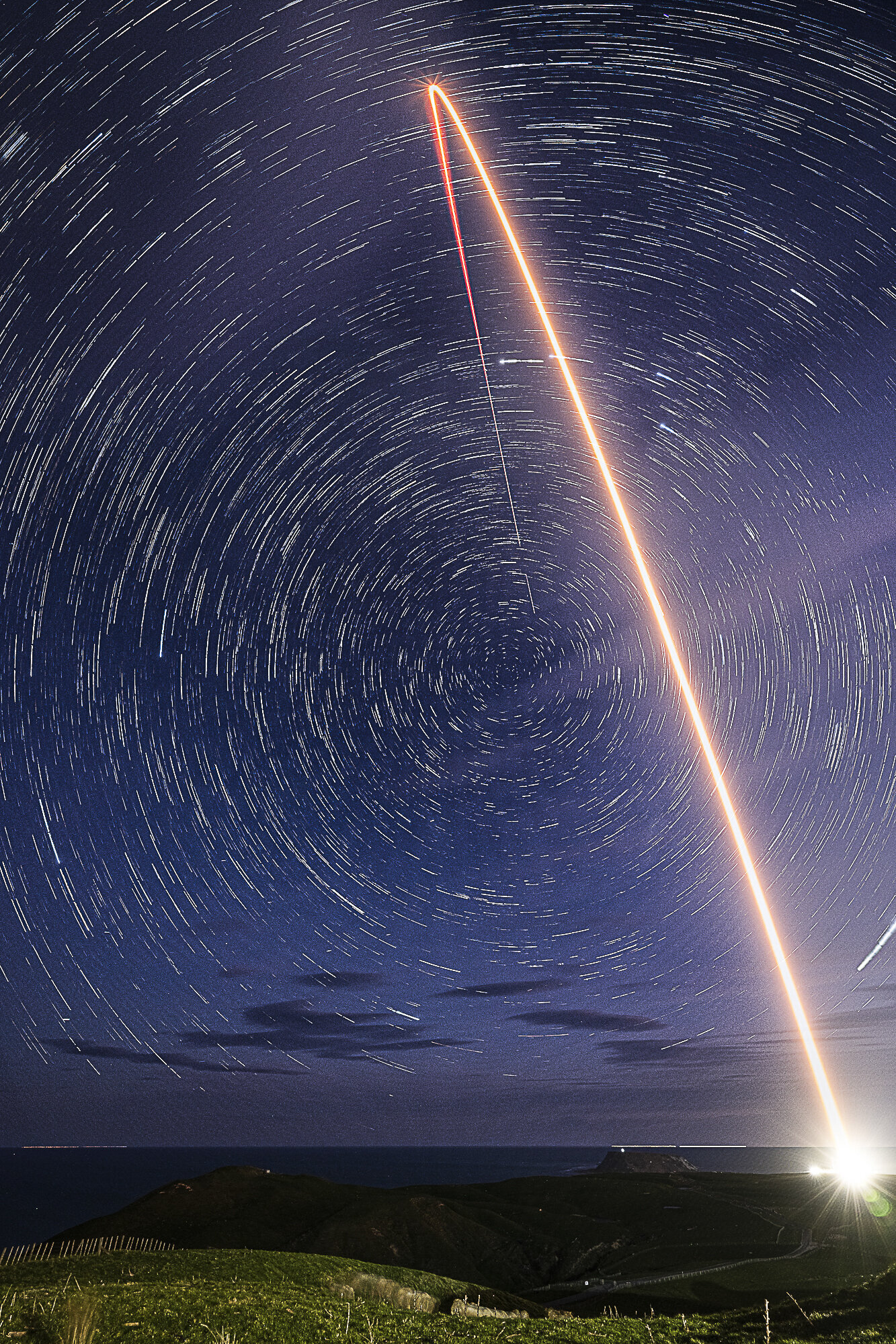 Rocket Lab's Electron rocket. Long exposure streak shot. Merged with star trail background.