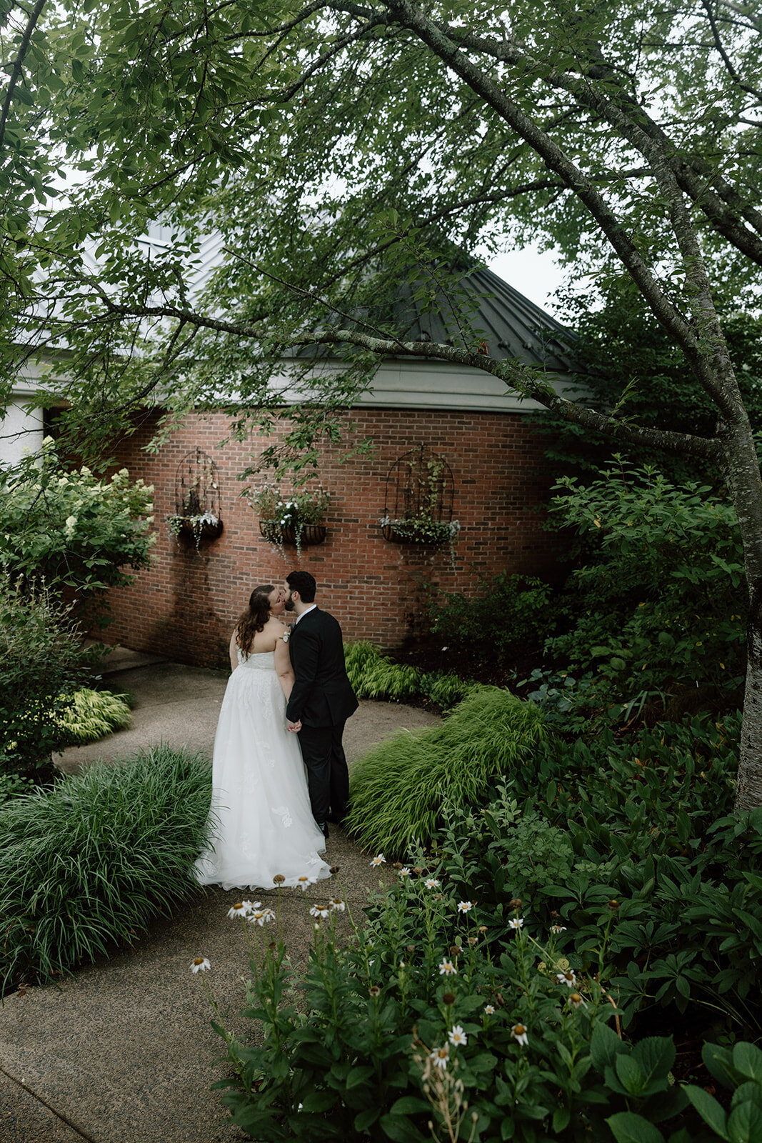 Florida garden ceremony kissing wedding couple holding hands
