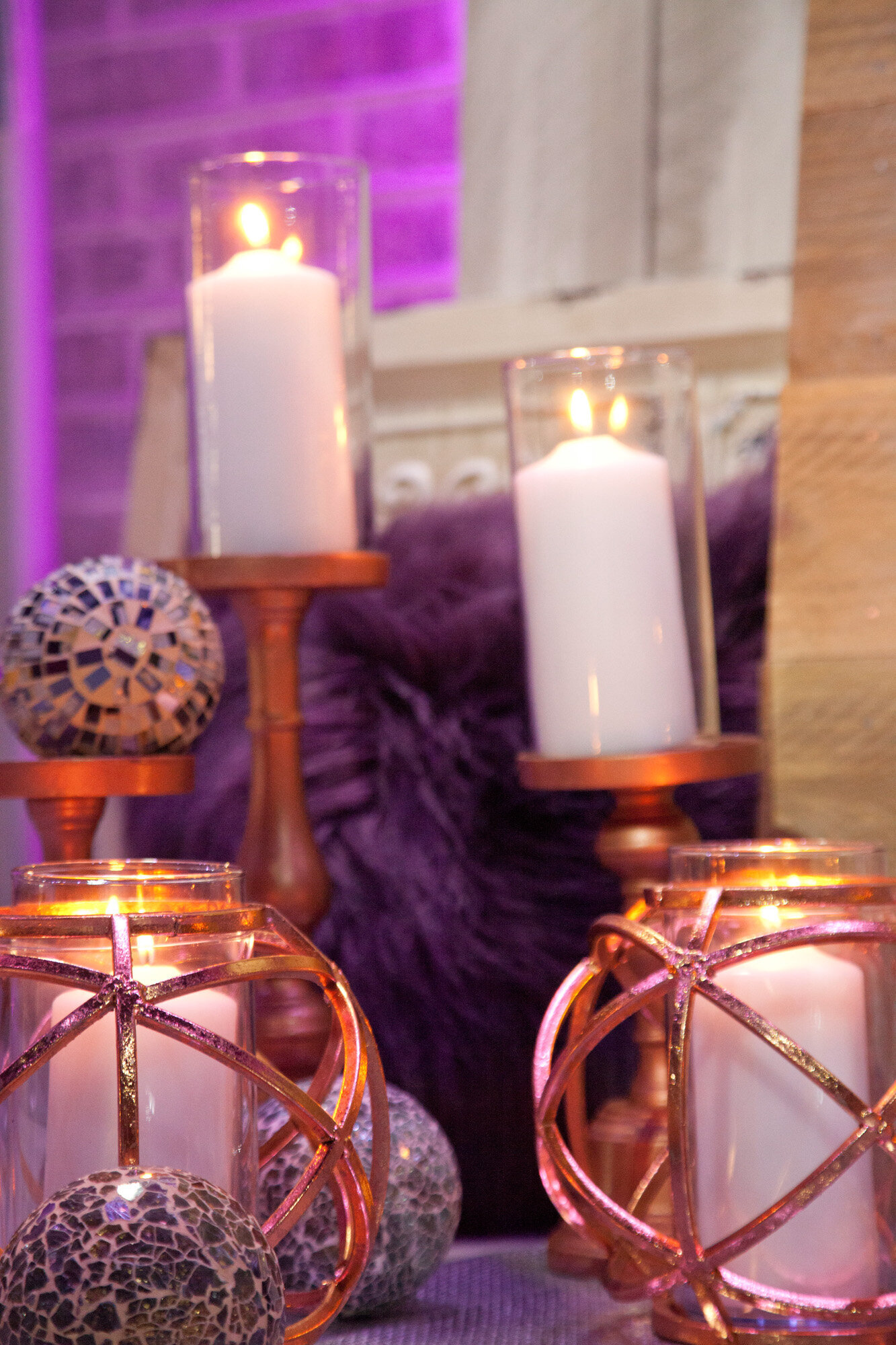 Lighted candle in a glass with purple background