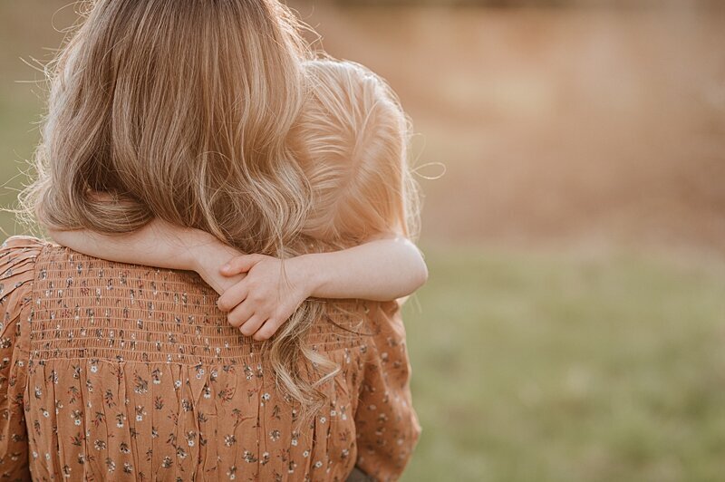 Little girl hugging mom tight by Vancouver Family Photographer